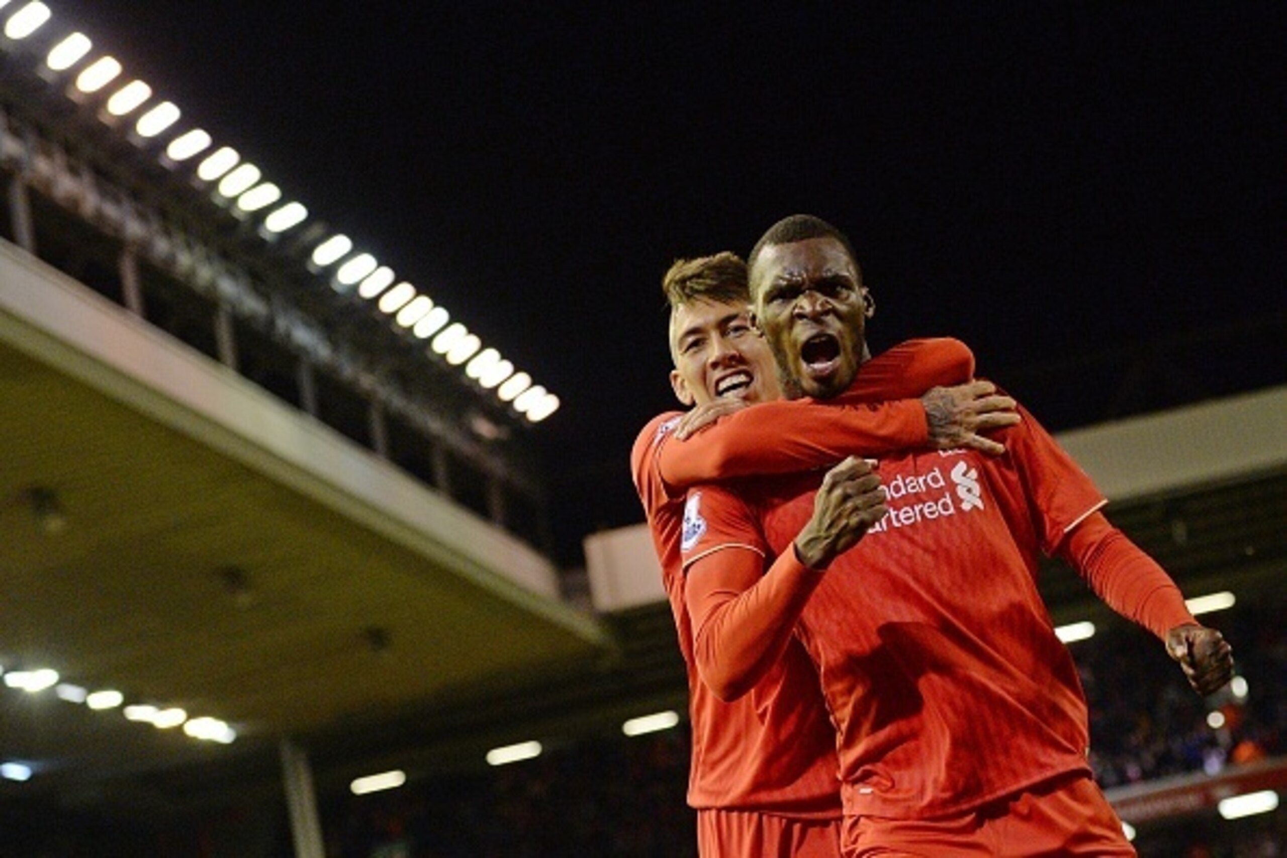 Liverpool's Zaire-born Belgian striker Christian Benteke celebrates with Liverpool's Brazilian midfielder Roberto Firmino (L) after scoring the opening goal of the English Premier League football match between Liverpool and Southampton at Anfield stadium 