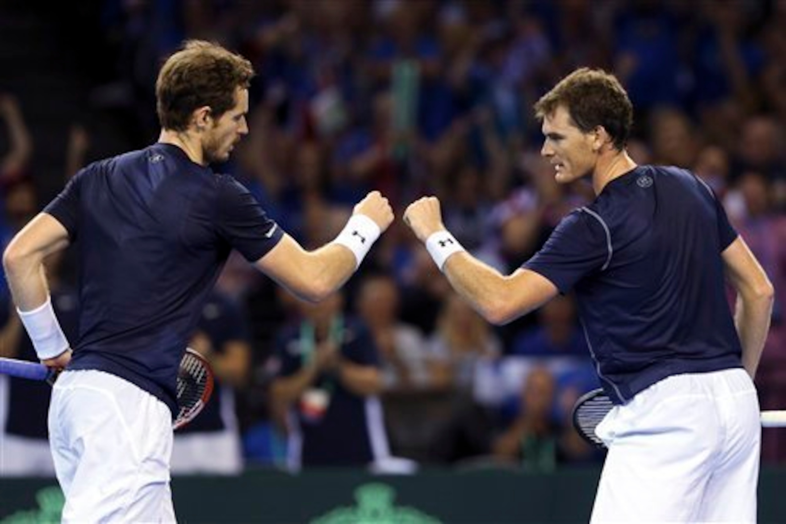 Andy Murray and his brother Jamie give each other fist bumps during a Davis Cup match against Australia. Andy Murray and his brother Jamie give each other fist bumps during a Davis Cup match against Australia.