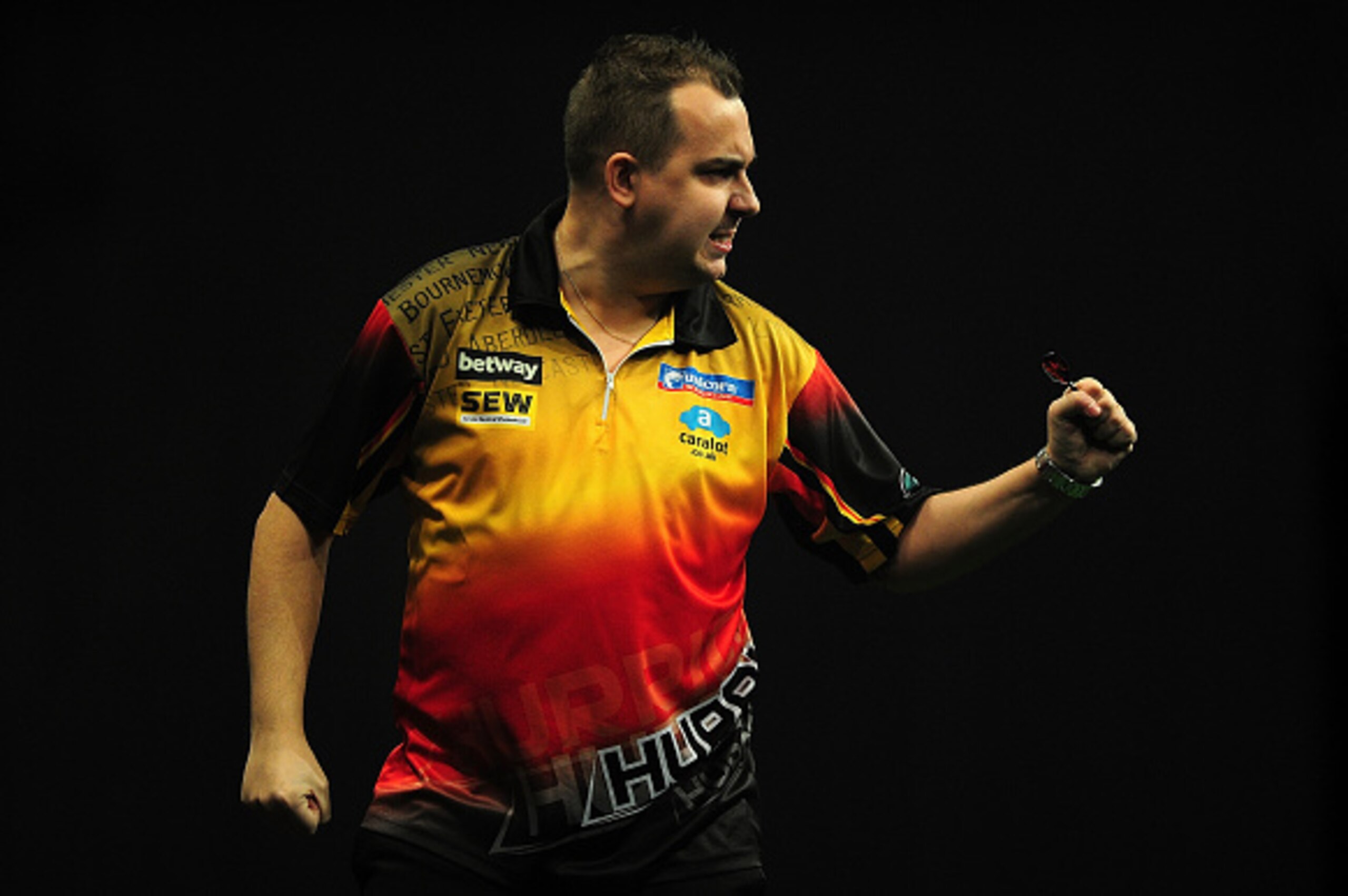 EXETER, ENGLAND - MARCH 05:  Kim Huybrechts of Belgium celebrates winning a leg against Raymond van Barneveld of Holland during The Betway Premier League Darts at Westpoint Arena on March 5, 2015 in Exeter, England.  (Photo by Dan Mullan/Getty Images)