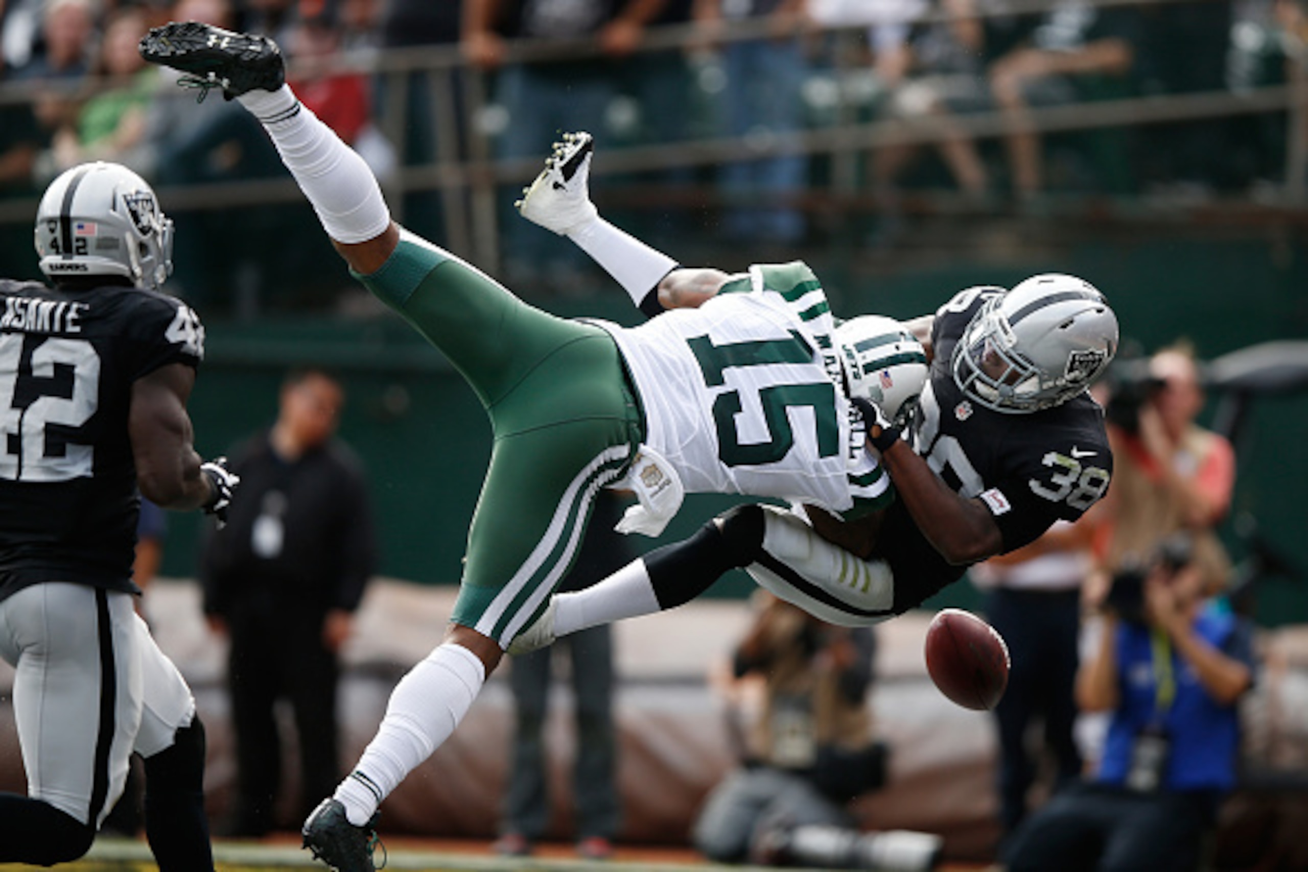 OAKLAND, CA - NOVEMBER 01:  T.J. Carrie #38 of the Oakland Raiders breaks up a pass intended for Brandon Marshall #15 of the New York Jets during their NFL game at O.co Coliseum on November 1, 2015 in Oakland, California.  (Photo by Ezra Shaw/Getty Images