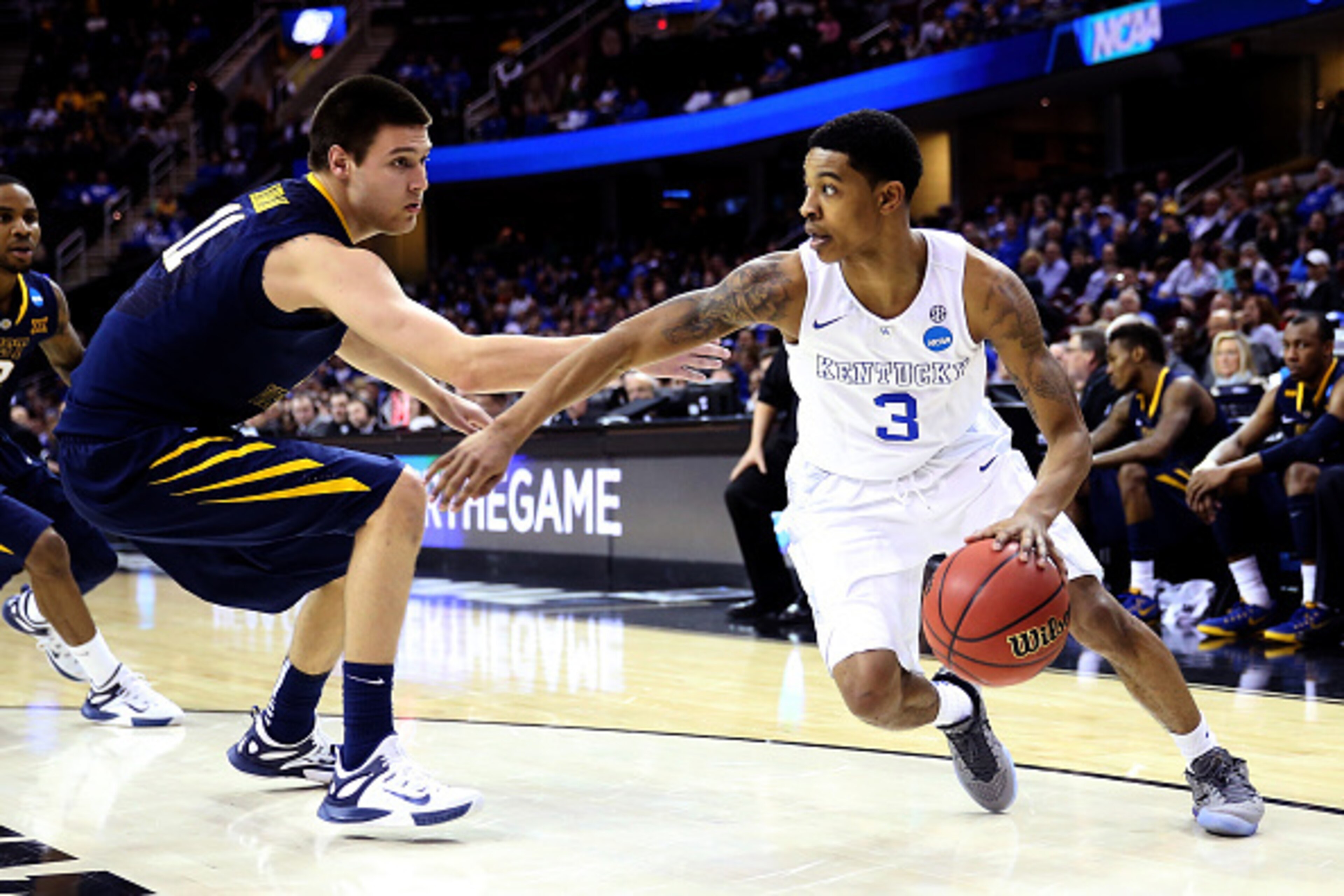 CLEVELAND, OH - MARCH 26: Tyler Ulis #3 of the Kentucky Wildcats handles the ball against Nathan Adrian #11 of the West Virginia Mountaineers in the second half during the Midwest Regional semifinal of the 2015 NCAA Men's Basketball Tournament at Quicken