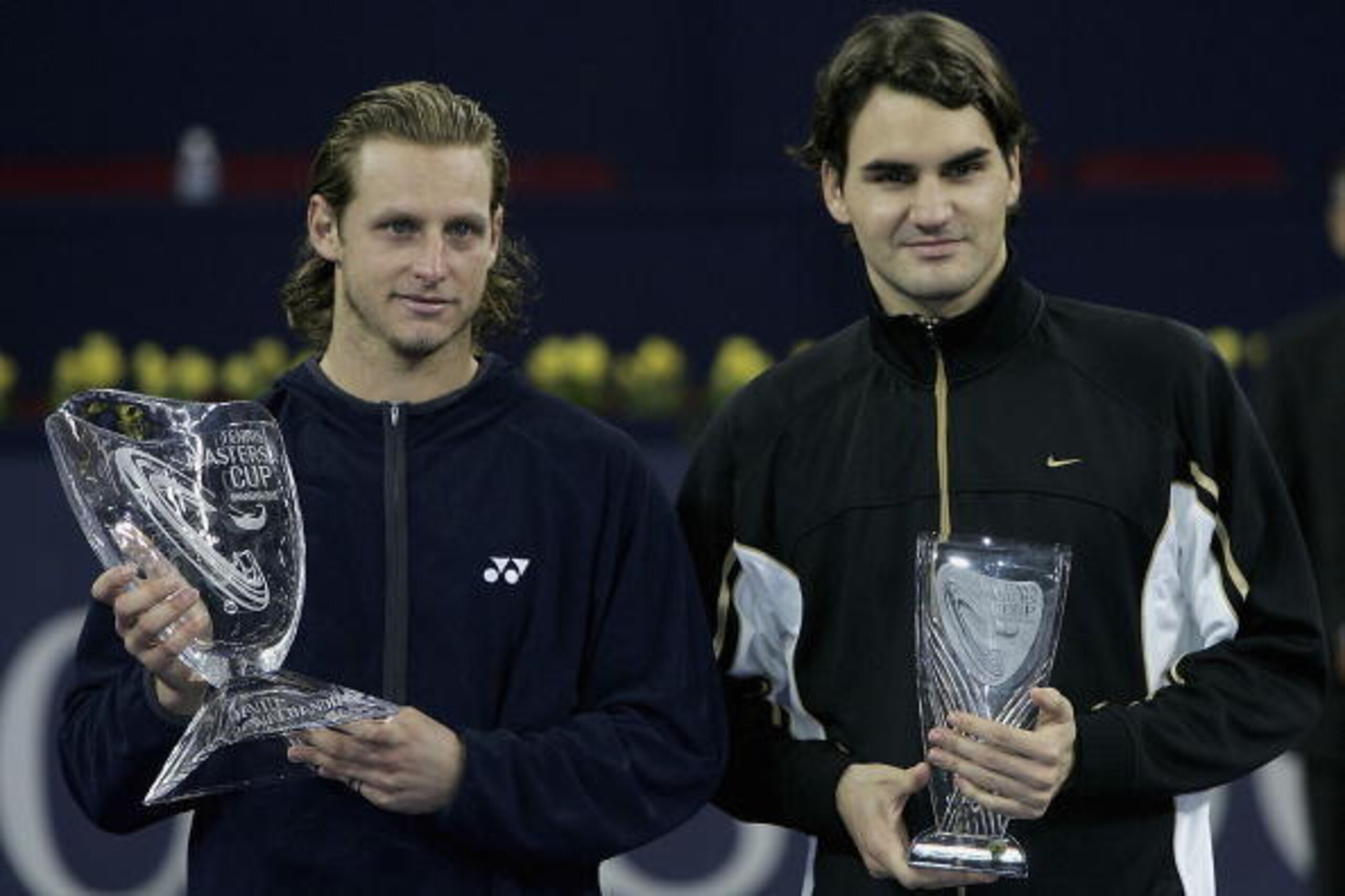 SHANGHAI - NOVEMBER 20: David Nalbandian of Argentina holds the trophy as Roger Federer looks on after his five set victory against Roger Federer of Switzerland in the final at the Qi Zhong Stadium , November 20, 2005 in Shanghai, China. (Photo by Clive SHANGHAI - NOVEMBER 20: David Nalbandian of Argentina holds the trophy as Roger Federer looks on after his five set victory against Roger Federer of Switzerland in the final at the Qi Zhong Stadium , November 20, 2005 in Shanghai, China. (Photo by Clive