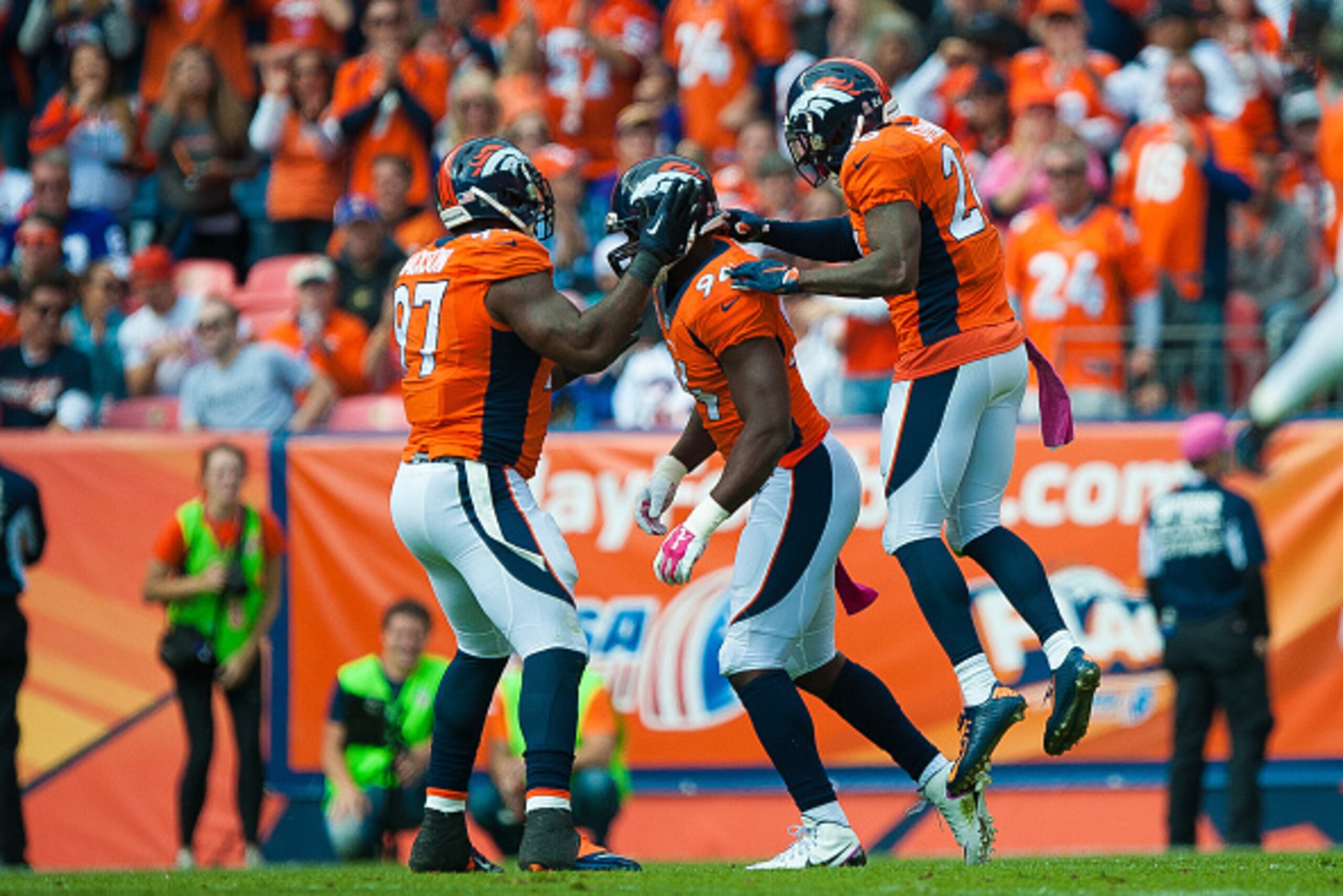 DENVER, CO - OCTOBER 4:  Denver Broncos defensive players, Malik Jackson #97, DeMarcus Ware #94, and Darian Stewart #26 celebrate a first quarter Ware sack against the Minnesota Vikings during a game at Sports Authority Field at Mile High on October 4, 20