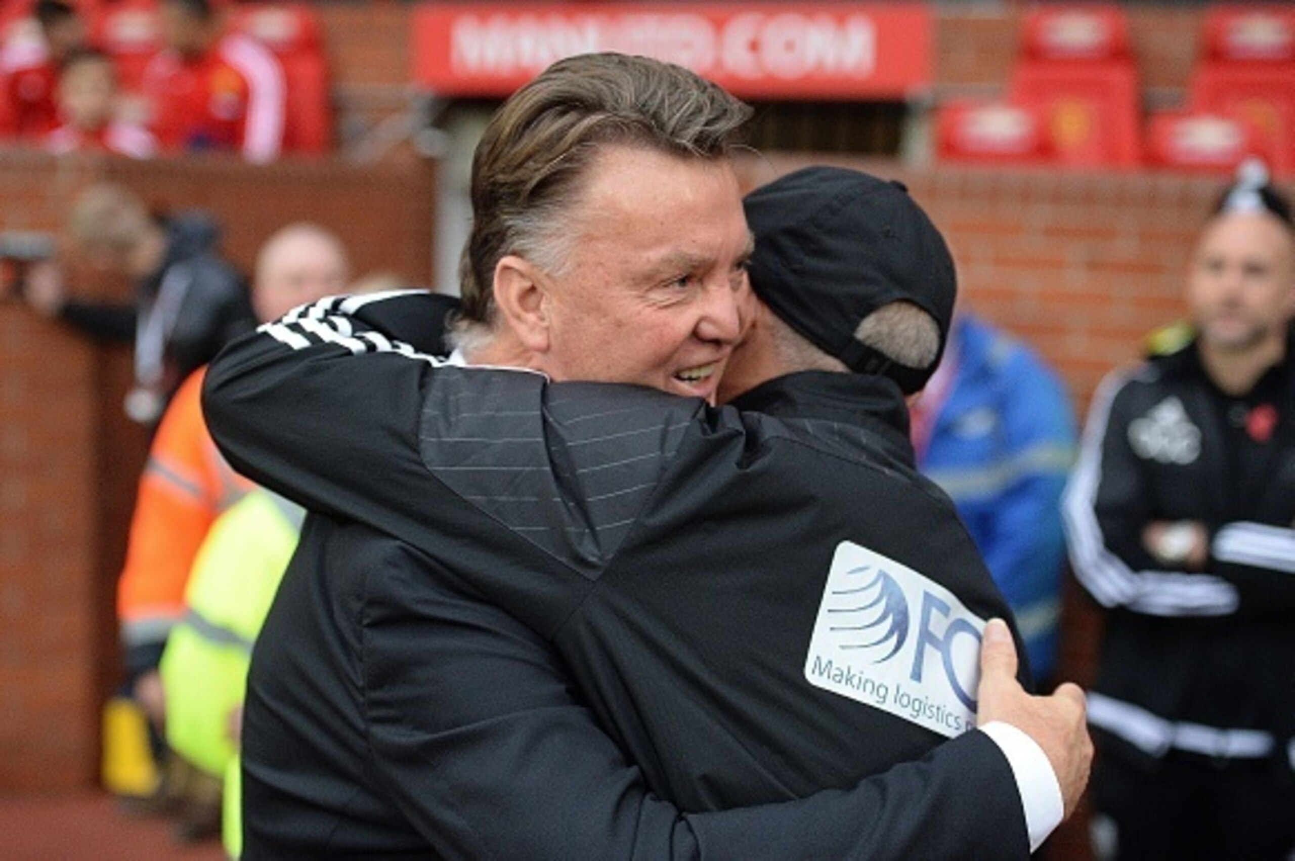 Manchester United's Dutch manager Louis van Gaal (L) hugs West Bromwich Albion's Welsh Head Coach Tony Pulis ahead of the English Premier League football match between Manchester United and West Bromwich Albion at Old Trafford stadium in Manchester, north