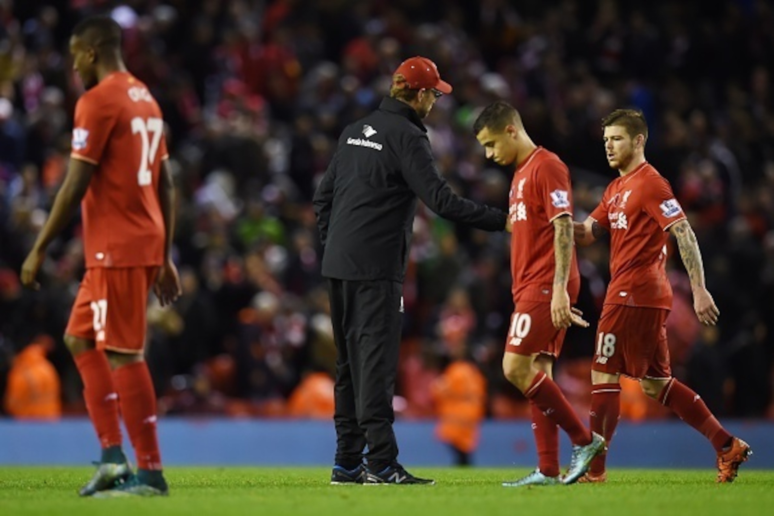 Liverpool's German manager Jurgen Klopp (C) greets his players after losing the English Premier League football match between Liverpool and Crystal Palace at the Anfield stadium in Liverpool, north-west England on November 8, 2015.     AFP PHOTO / PAUL EL