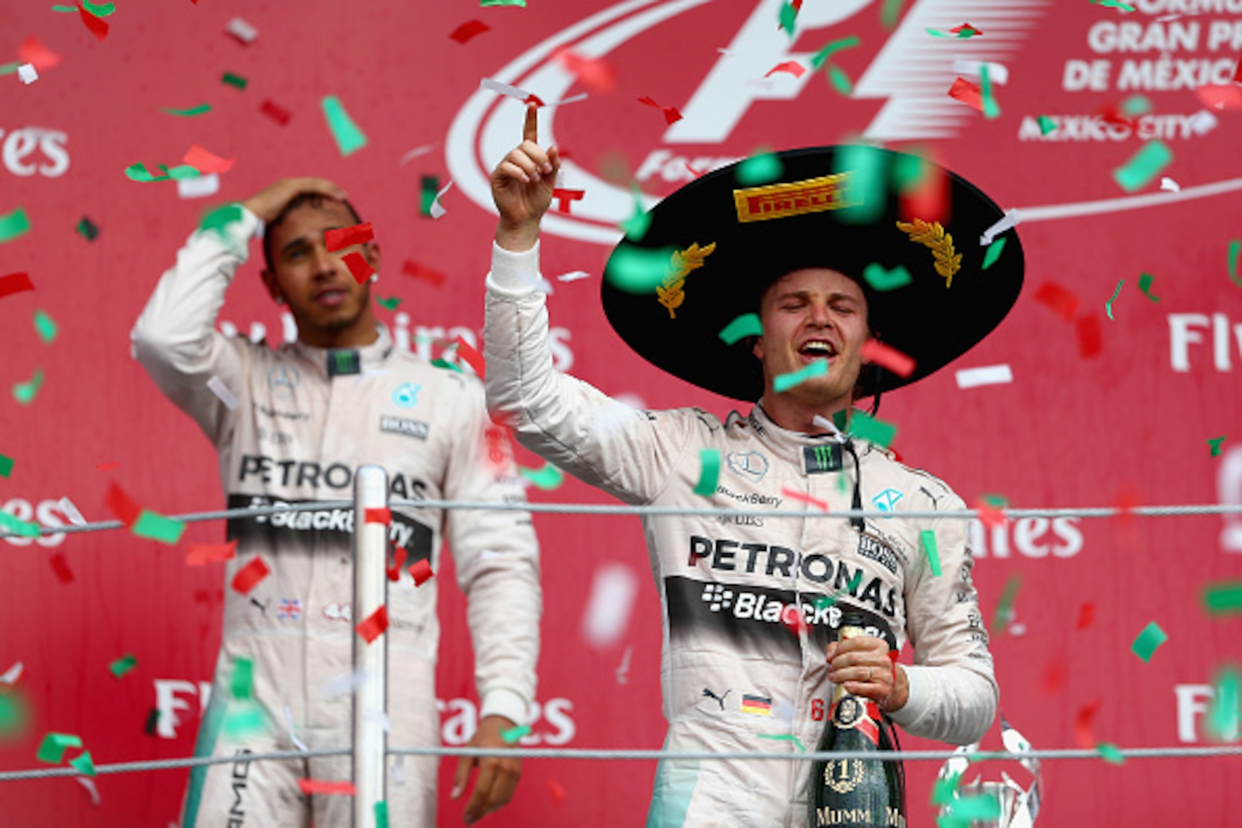MEXICO CITY, MEXICO - NOVEMBER 01:  Nico Rosberg of Germany and Mercedes GP celebrates on the podium next to Lewis Hamilton of Great Britain and Mercedes GP after winning the Formula One Grand Prix of Mexico at Autodromo Hermanos Rodriguez  on November 1,