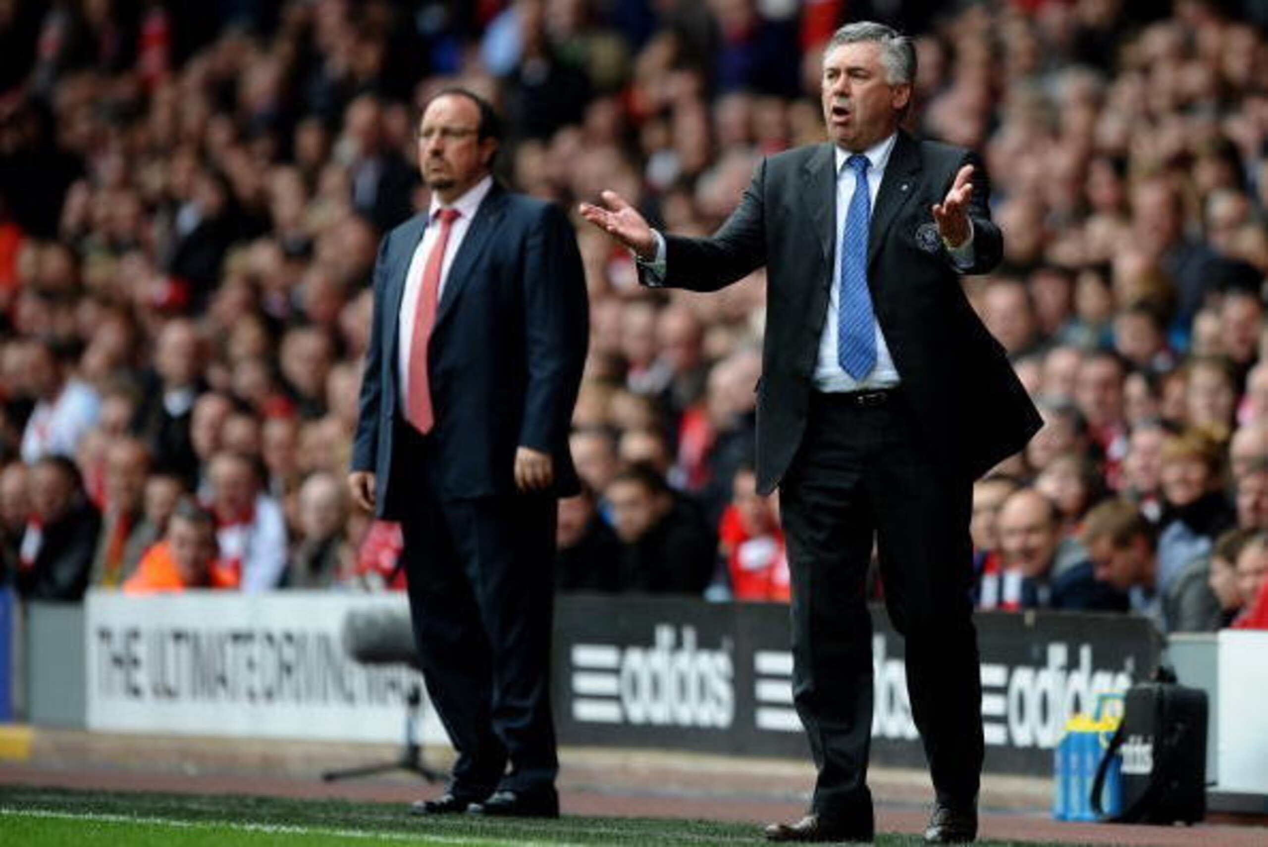 LIVERPOOL, ENGLAND - MAY 02:  Carlo Ancelotti the Chelsea manager reacts to events on the pitch as Rafael Benitez the Liverpool manager looks on during the Barclays Premier League match between Liverpool and Chelsea at Anfield on May 2, 2010 in Liverpool,