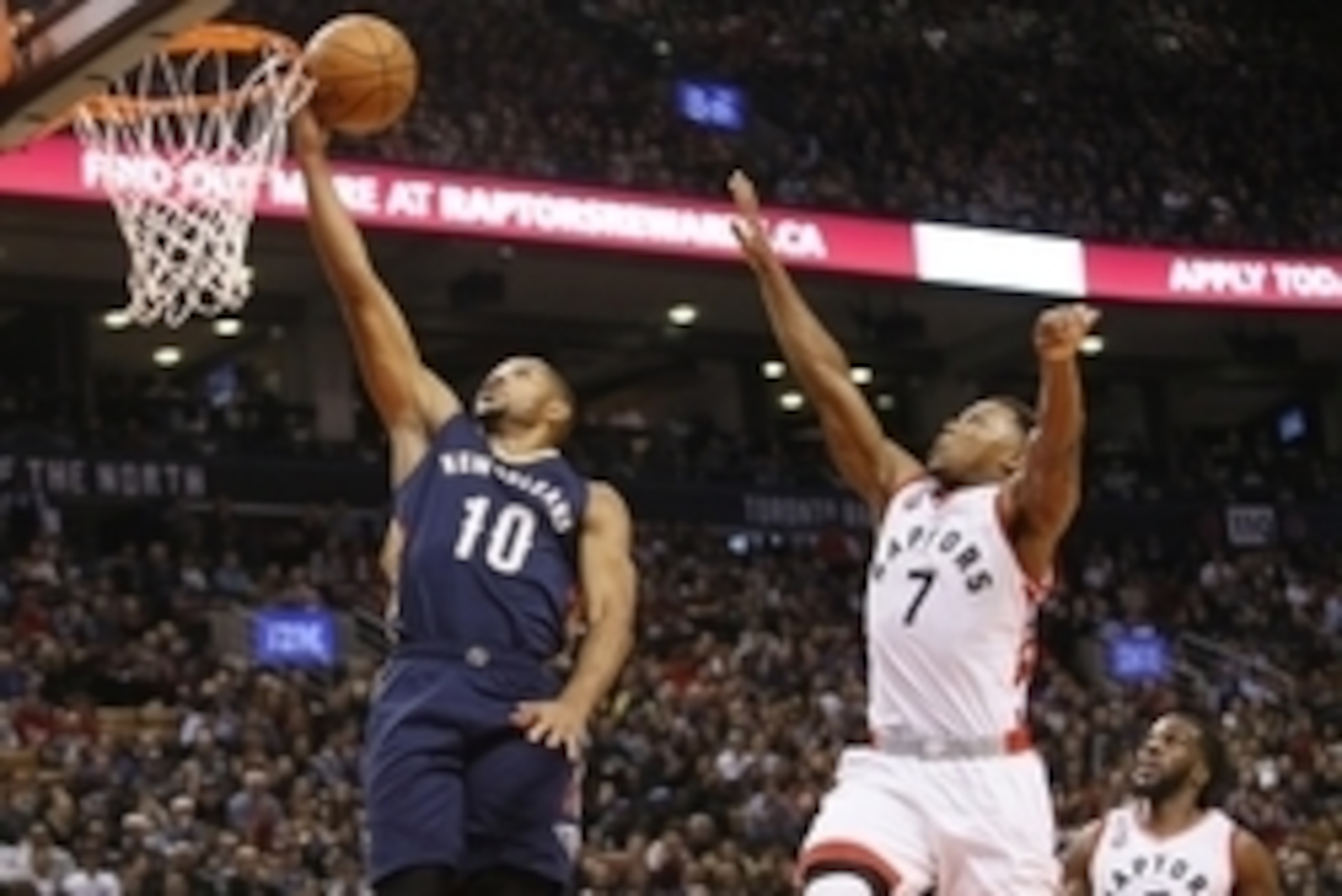 Nov 13, 2015; Toronto, Ontario, CAN; New Orleans Pelicans guard Eric Gordon (10) goes to make a basket as Toronto Raptors guard Kyle Lowry (7) and forward DeMarre Carroll (5) look on during the first half at Air Canada Centre. Mandatory Credit: John E. So
