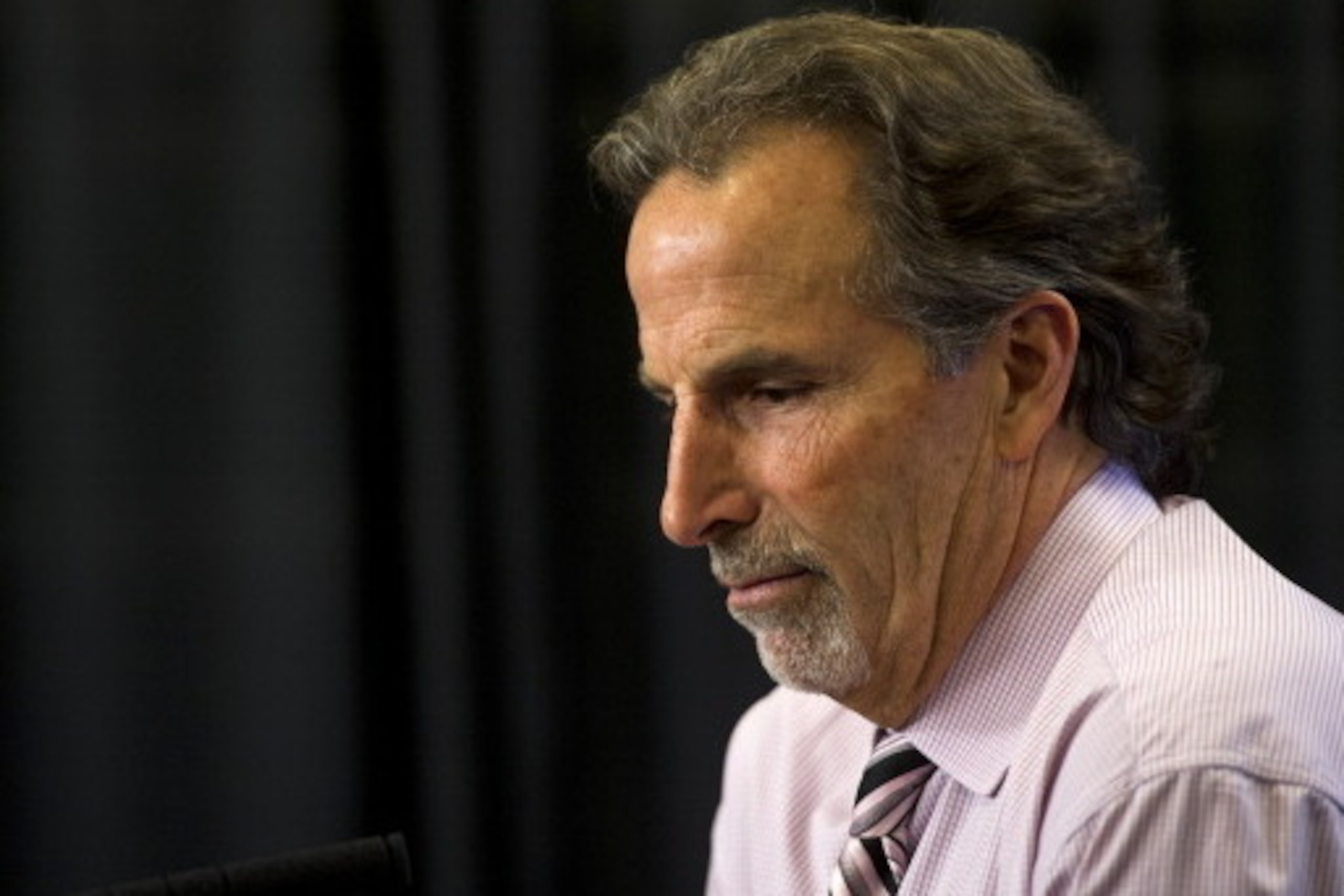 VANCOUVER, BC - APRIL 13: Head coach John Tortorella of the Vancouver Canucks reflects on a question during his post-game press conference after defeating the Calgary Flames 5-1 in NHL action on April 13, 2014 at Rogers Arena in Vancouver, British Columb VANCOUVER, BC - APRIL 13: Head coach John Tortorella of the Vancouver Canucks reflects on a question during his post-game press conference after defeating the Calgary Flames 5-1 in NHL action on April 13, 2014 at Rogers Arena in Vancouver, British Columb