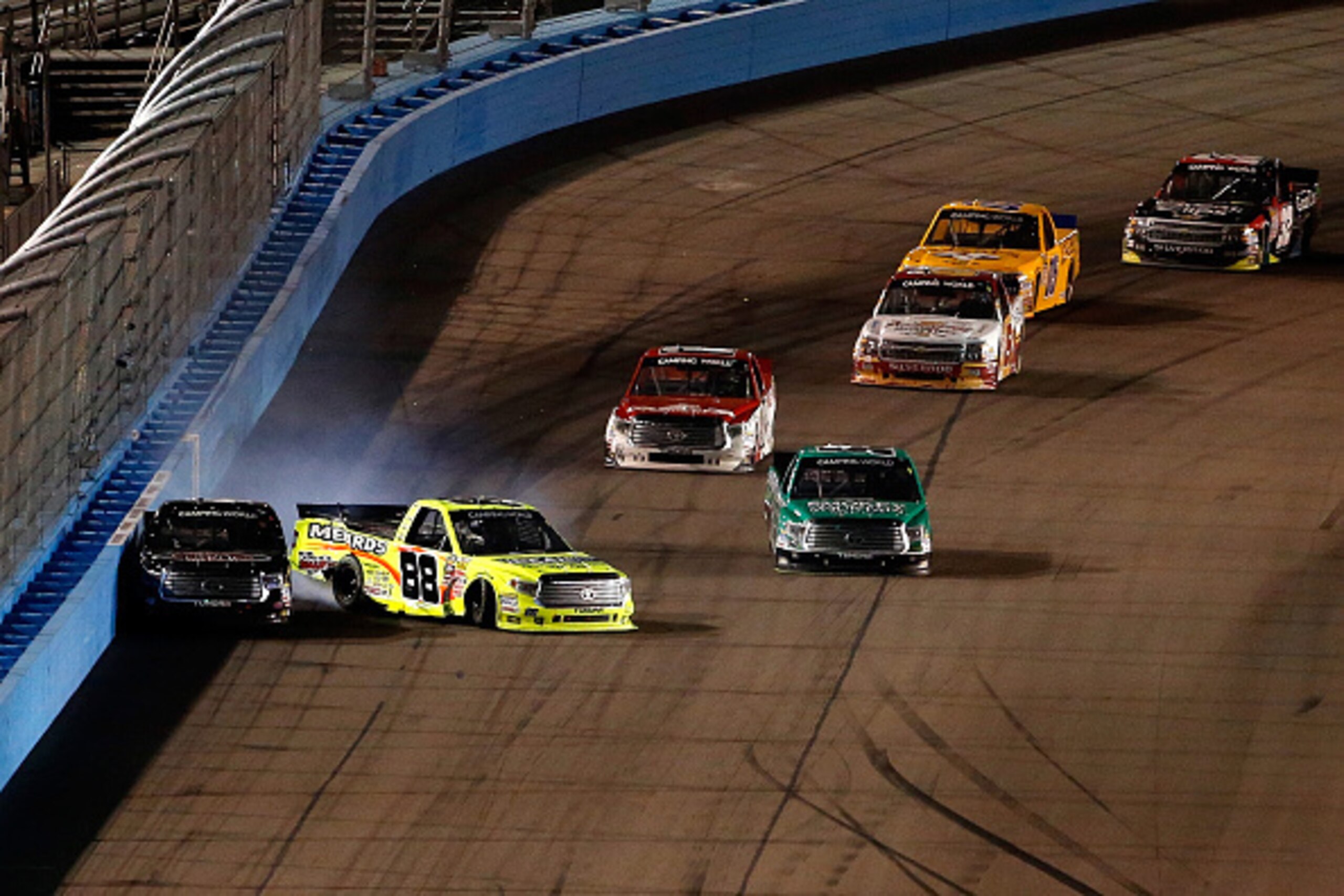 AVONDALE, AZ - NOVEMBER 13:  Matt Crafton, driver of the #88 Ideal Door/Menards Toyota, hits Erik Jones, driver of the #4 Toyota Certified Used Vehicles Toyota, during the NASCAR Camping World Truck Series Lucas Oil 150 at Phoenix International Raceway on