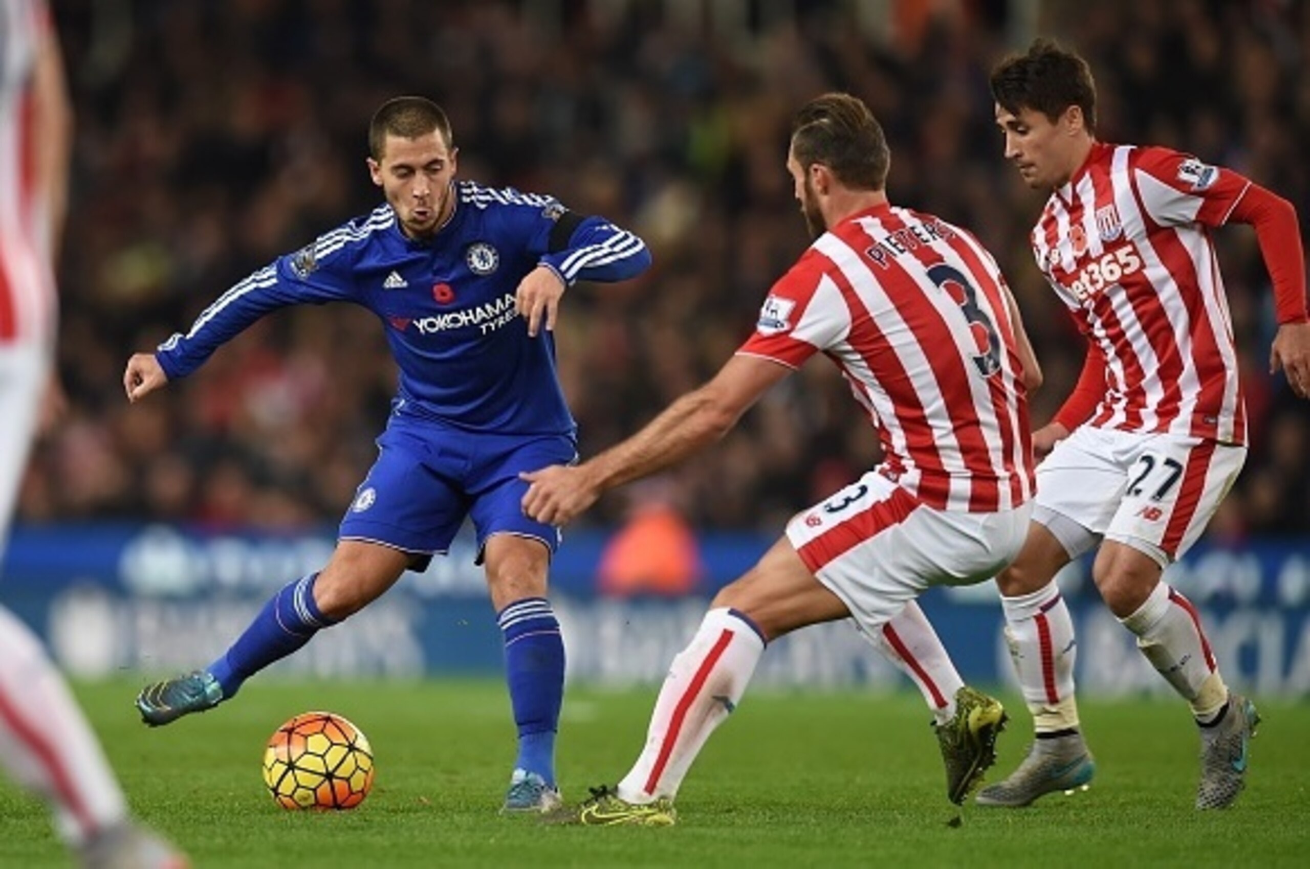 Chelsea's Belgian midfielder Eden Hazard (L) vies with Stoke City's Dutch defender Erik Pieters and Stoke City's Spanish striker Bojan Krkic (R) during the English Premier League football match between Stoke City and Chelsea at the Britannia Stadium in St Chelsea's Belgian midfielder Eden Hazard (L) vies with Stoke City's Dutch defender Erik Pieters and Stoke City's Spanish striker Bojan Krkic (R) during the English Premier League football match between Stoke City and Chelsea at the Britannia Stadium in St
