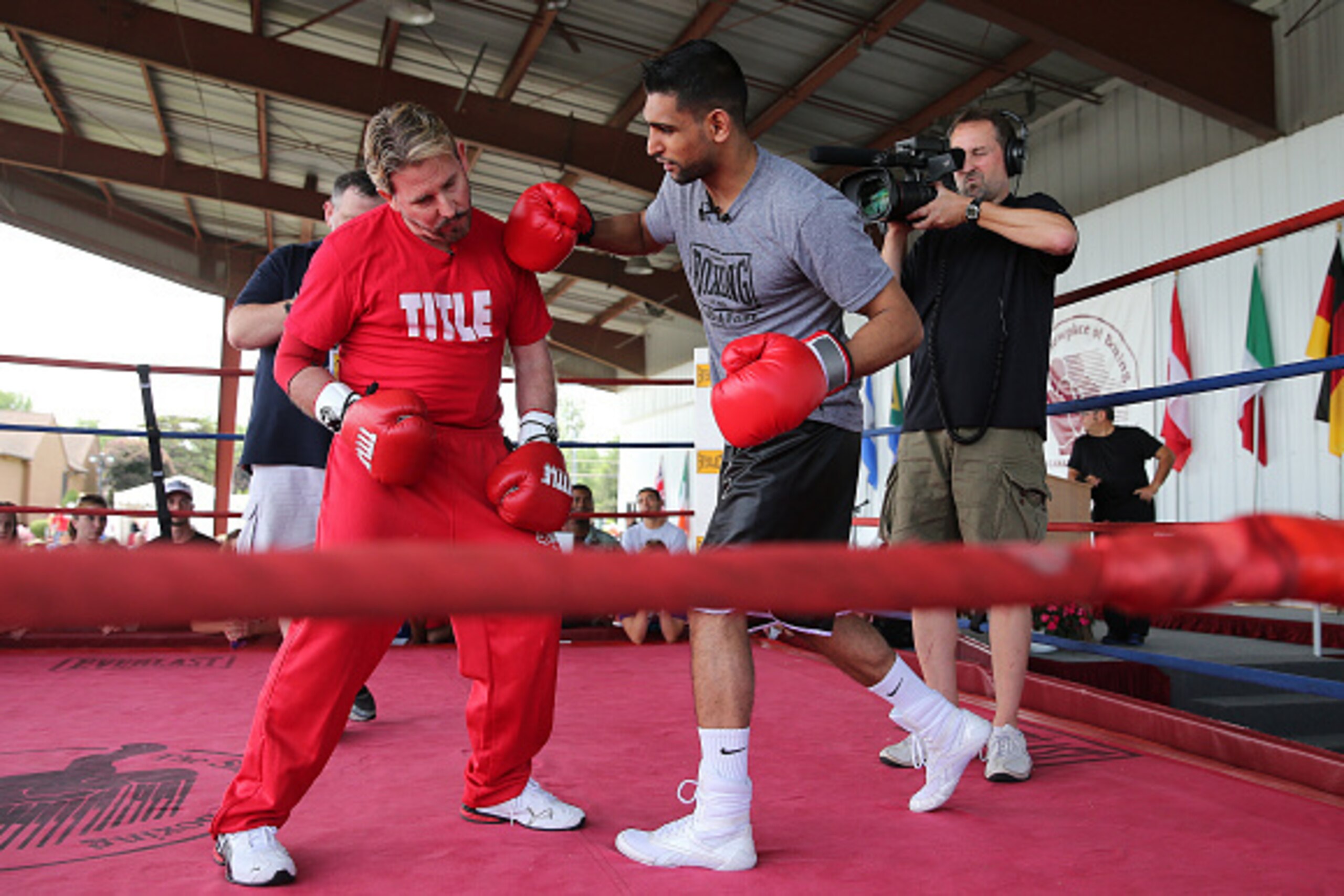 CANASTOTA, NY - JUNE 13: Boxing champion Amir Khan (R) walks through a boxing demo with James 'Smitty' Smith during a boxing demo at the International Boxing Hall of Fame induction Weekend of Champions events on June 13, 2015 in Canastota, New York. (Phot