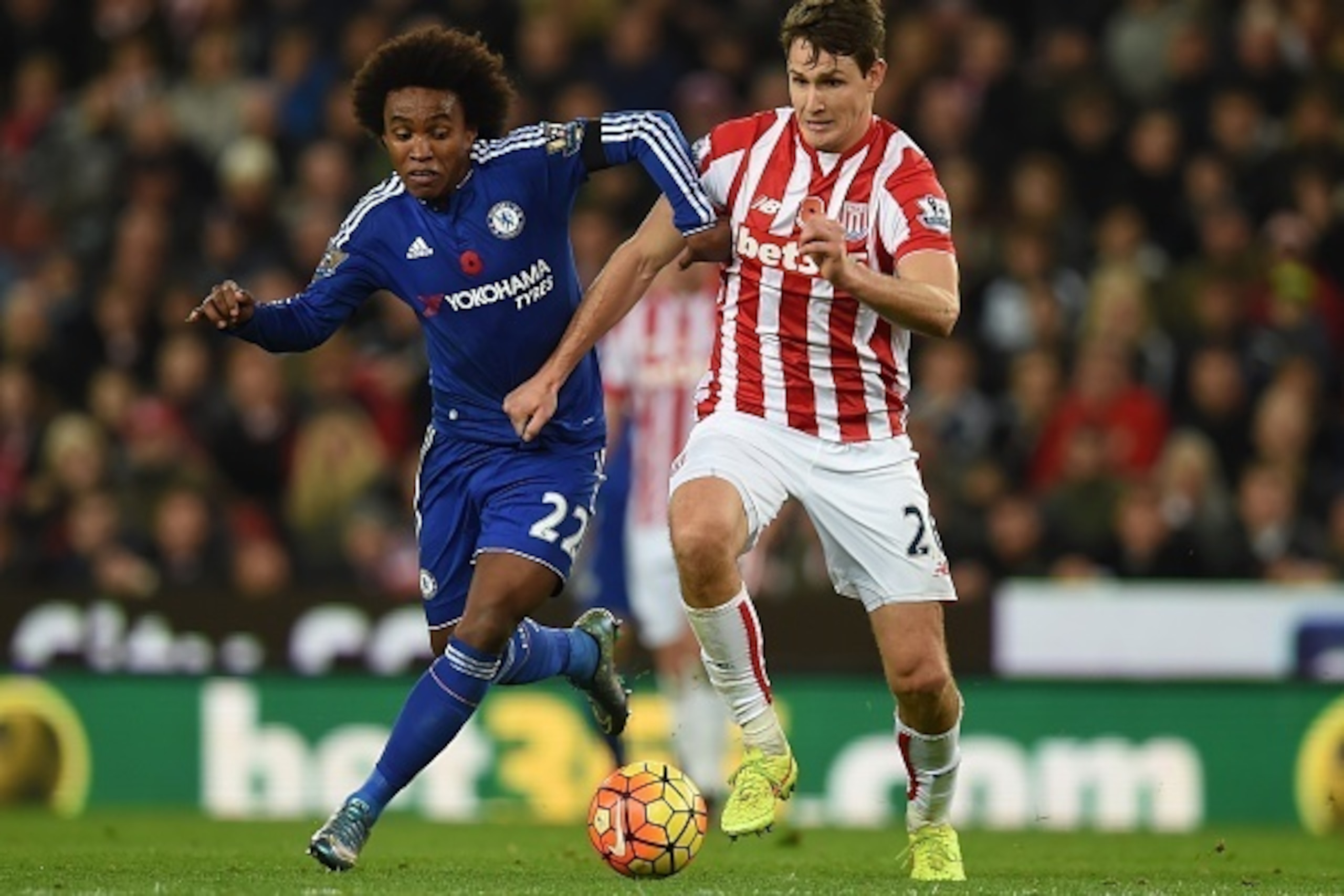 Chelsea's Brazilian midfielder Willian (L) vies with Stoke City's German defender Philipp Wollscheid during the English Premier League football match between Stoke City and Chelsea at the Britannia Stadium in Stoke-on-Trent, central England on November 7,