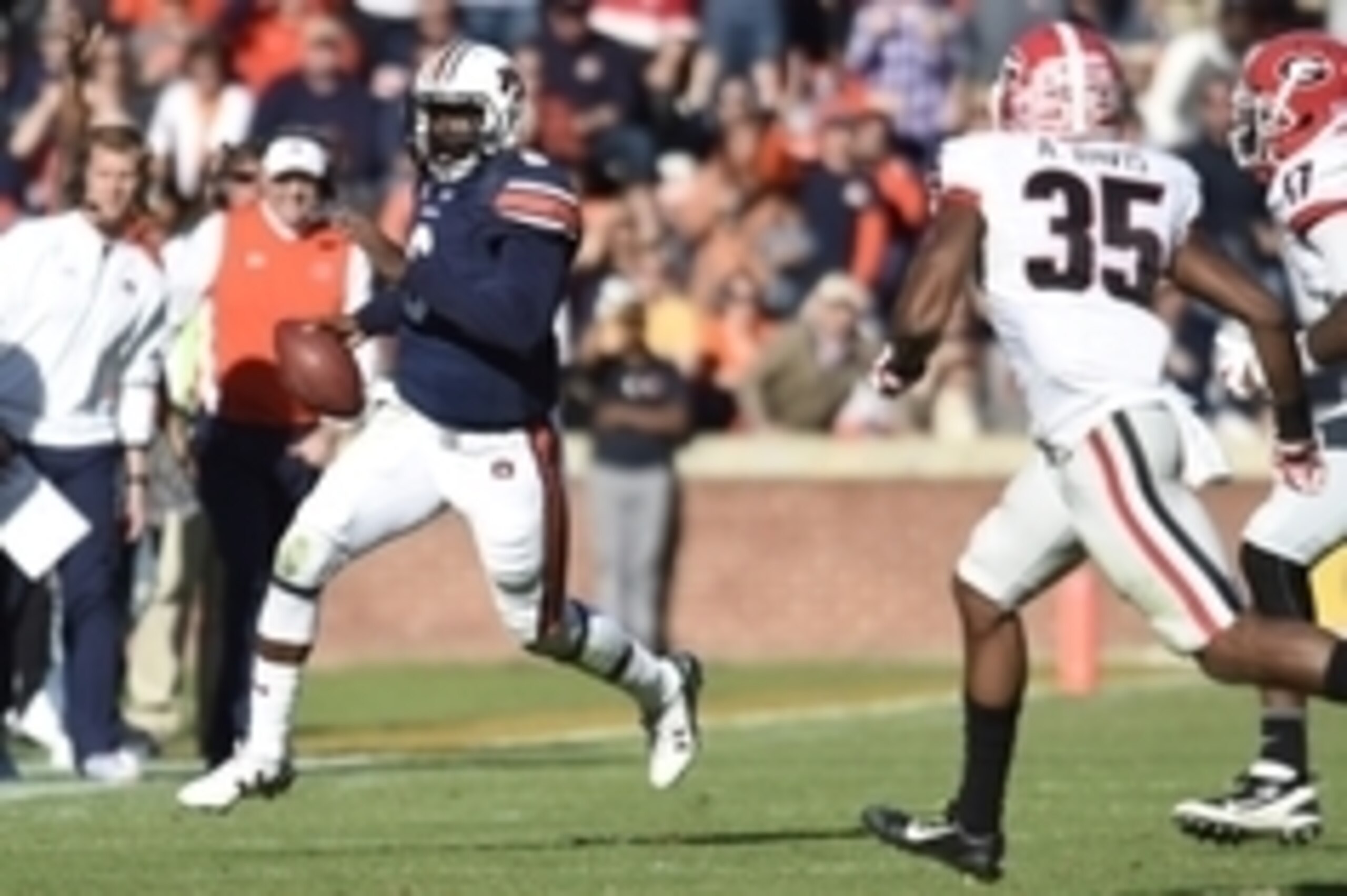 Nov 14, 2015; Auburn, AL, USA; Auburn Tigers quarterback Jeremy Johnson (6) runs the ball as Georgia Bulldogs cornerback Aaron Davis (35) defends during the fourth quarter at Jordan Hare Stadium. Georgia won 20-13. Mandatory Credit: Shanna Lockwood-USA TO