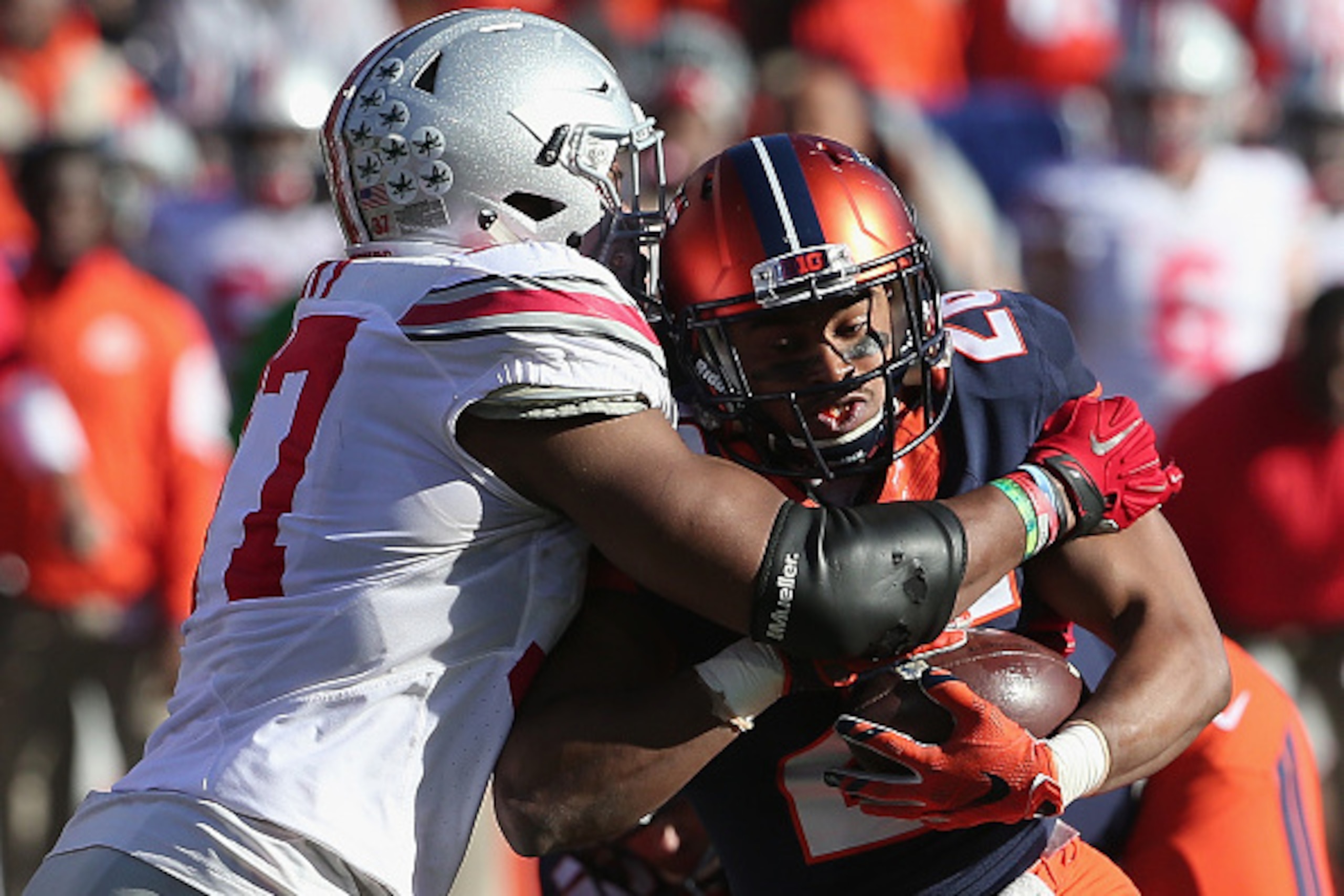 CHAMPAIGN, IL - NOVEMBER 14:  Cameron Tucker #26 of the Illinois Fighting Illini is tackled for a loss by Joshua Perry #37 of the Ohio State Buckeyes at Memorial Stadium on November 14, 2015 in Champaign, Illinois.  (Photo by Jonathan Daniel/Getty Images)