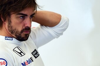 McLaren Honda's Spanish driver Fernando Alonso looks on in the pits before the third practice session at the Spa-Francorchamps ciruit in Spa on August 22, 2015, ahead of the Belgian Formula One Grand Prix. AFP PHOTO / EMMANUEL DUNAND        (Photo credit 