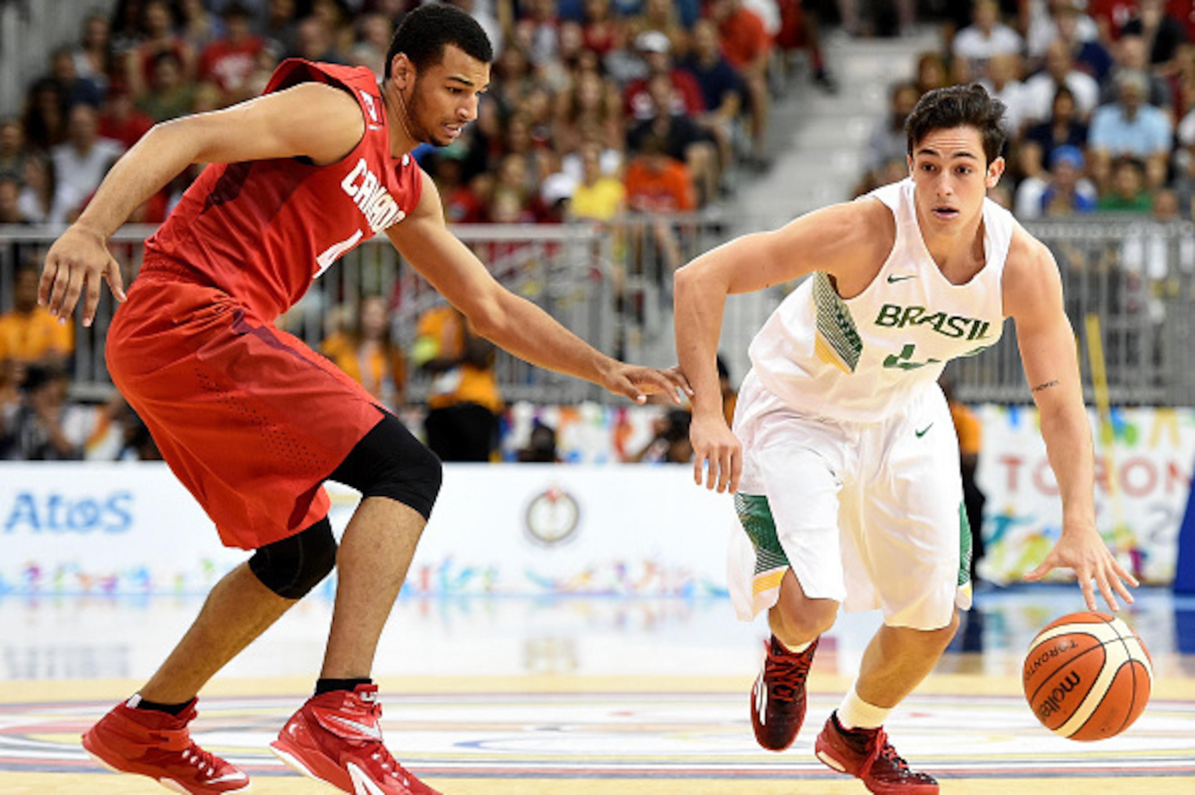 TORONTO, ON - JULY 25:  Ricardo Fischer of Brazil drives to the basket on Jamal Murray #4 of Canada in men's basketball during the 2015 Pan Am Games at the Ryerson Athletic Centre on July 25, 2015 in Toronto, Canada.  (Photo by Harry How/Getty Images)