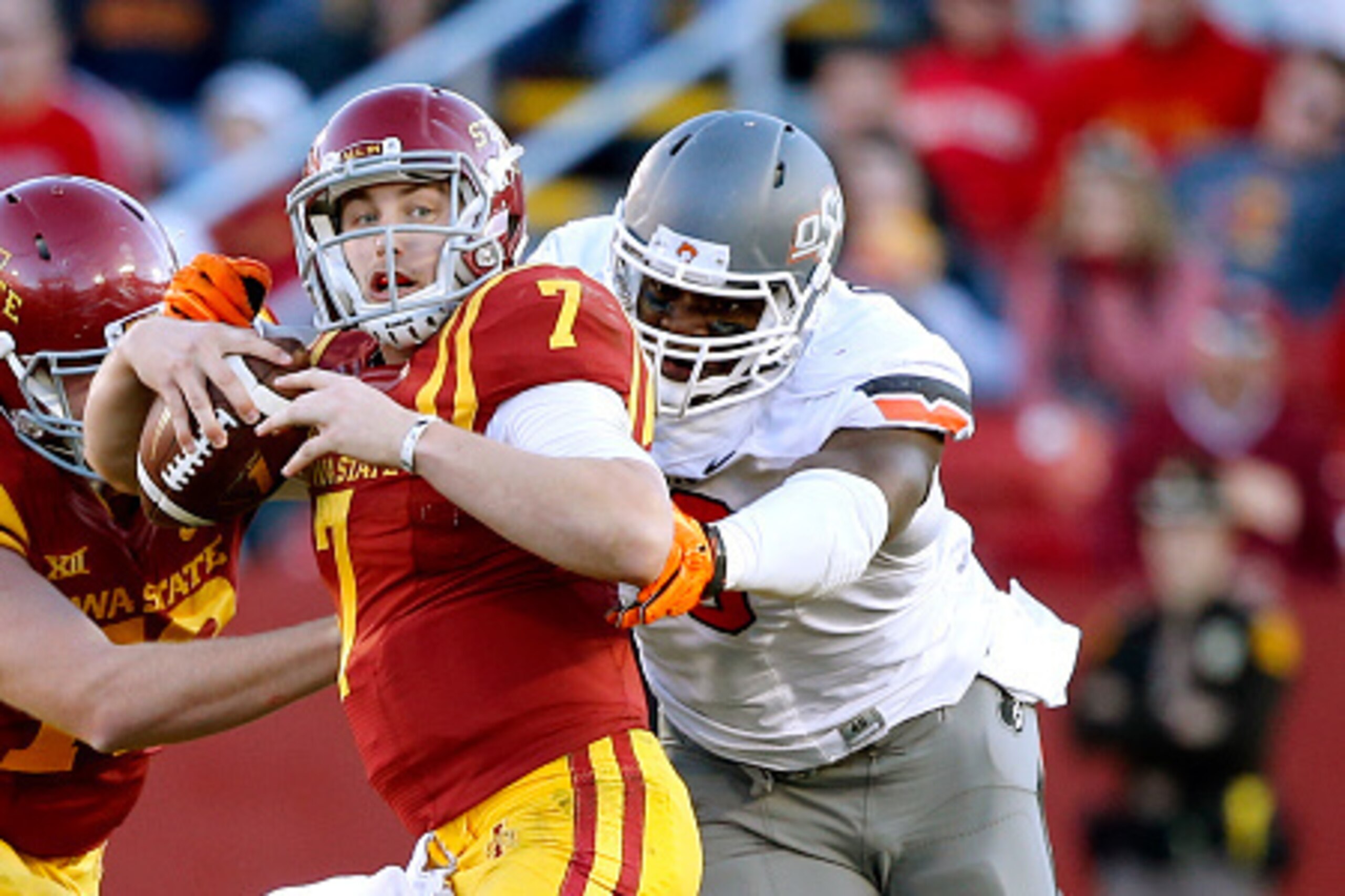 AMES, IA - NOVEMBER 14: Quarterback Joel Lanning #7 of the Iowa State Cyclones is sacked by defensive end Emmanuel Ogbah #38 of the Oklahoma State Cowboys in the first half of play at Jack Trice Stadium on November 14, 2015 in Ames, Iowa. (Photo by David 