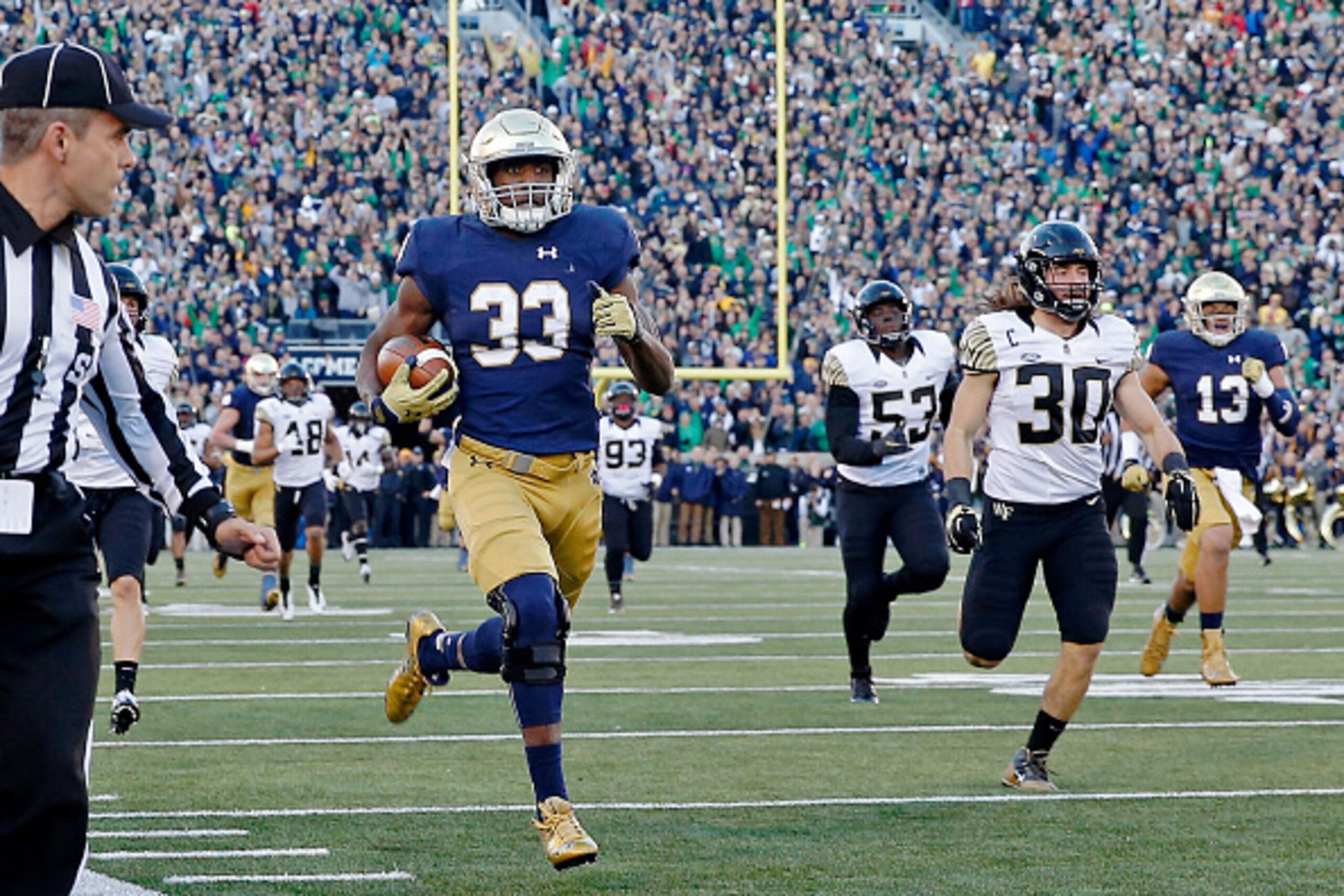 SOUTH BEND, IN - NOVEMBER 14:  Josh Adams #33 of the Notre Dame Fighting Irish rushes for a 98-yard touchdown against the Wake Forest Demon Deacons during the second quarter at Notre Dame Stadium on November 14, 2015 in South Bend, Indiana.  (Photo by Jon
