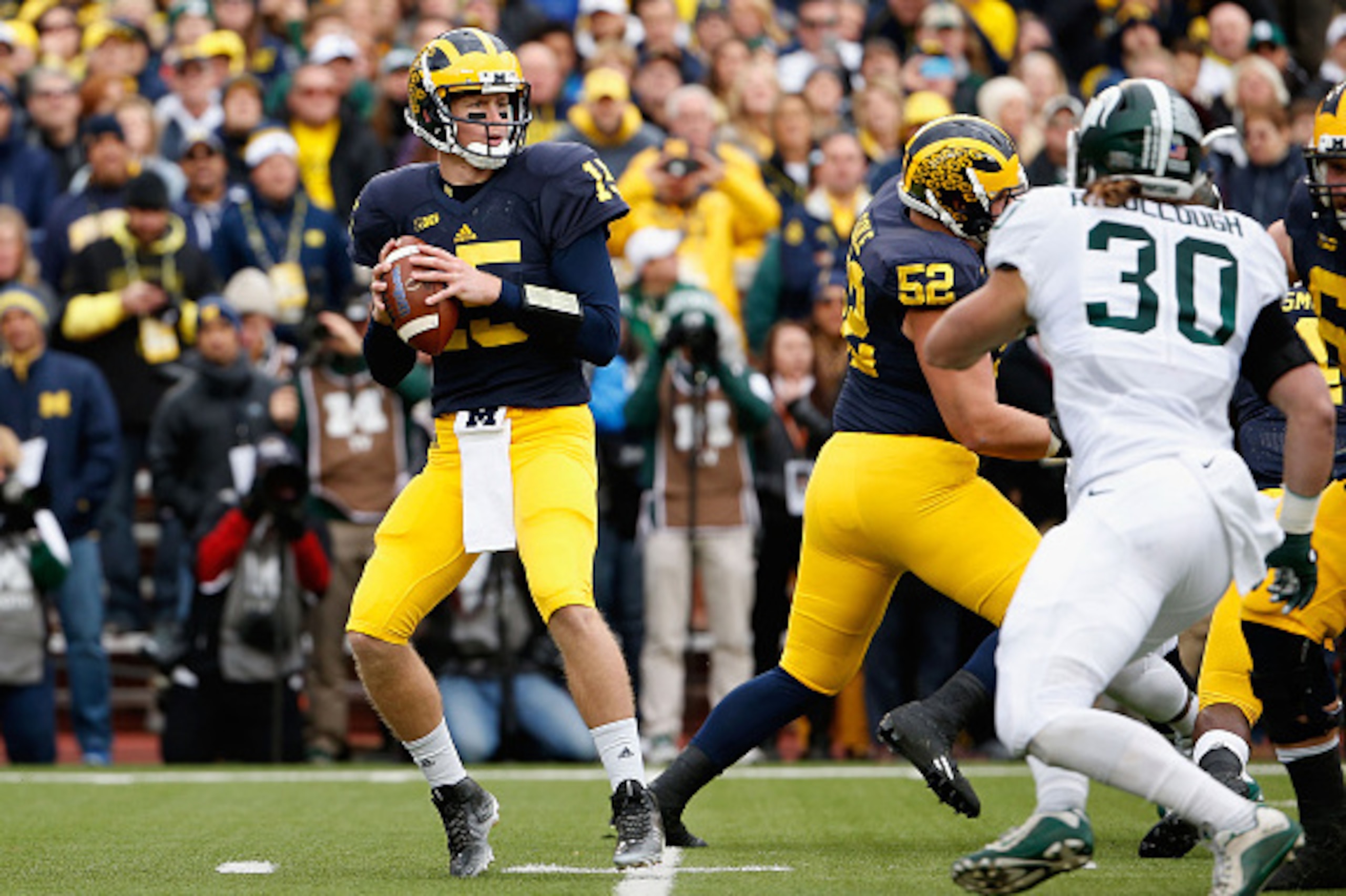 ANN ARBOR, MI - OCTOBER 17:  Quarterback Jake Rudock #15 of the Michigan Wolverines drops back to pass during the college football game against the Michigan State Spartans at Michigan Stadium on October 17, 2015 in Ann Arbor, Michigan. The Spartans defeat