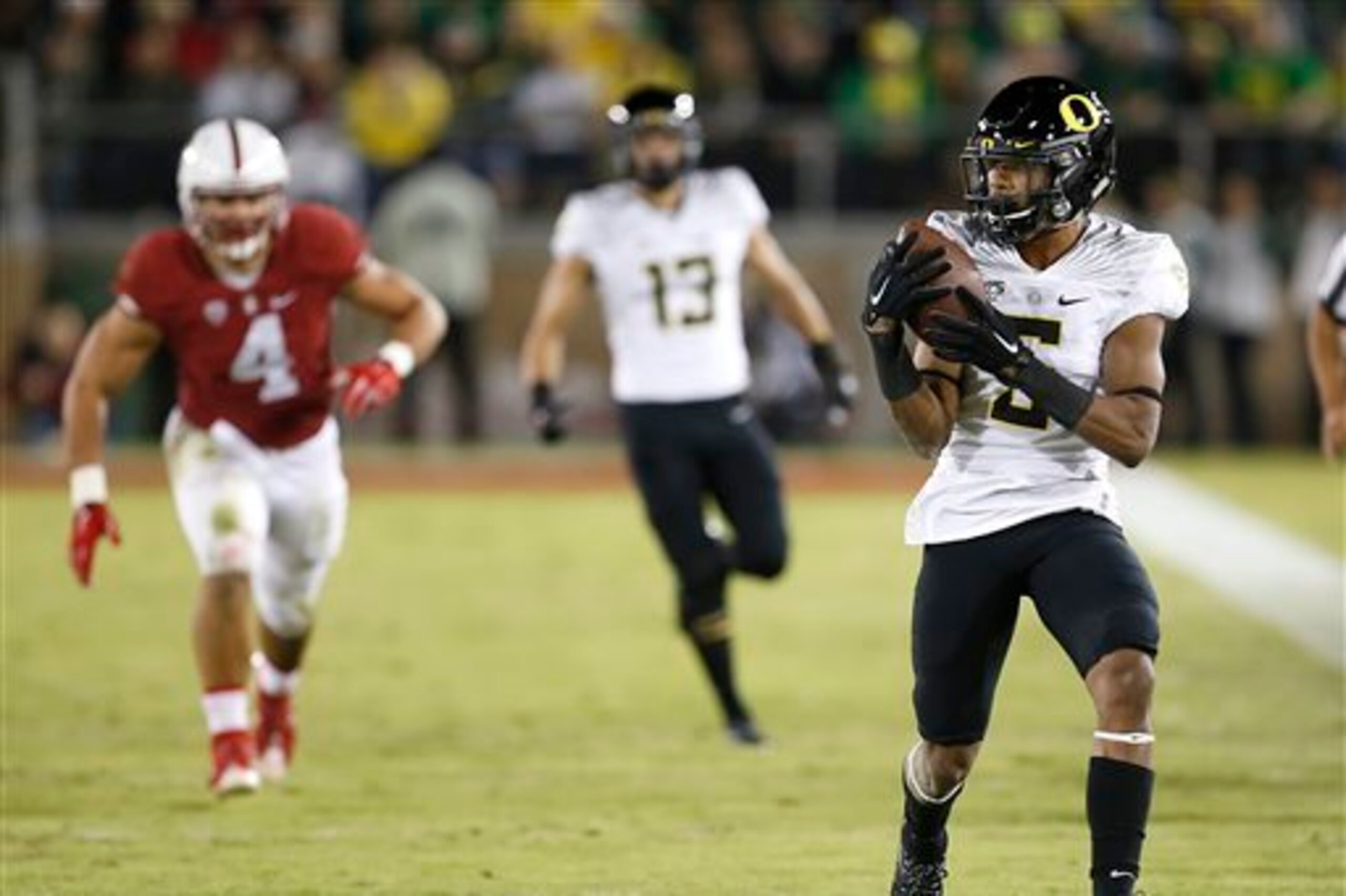 Oregon RB Taj Griffin (right)