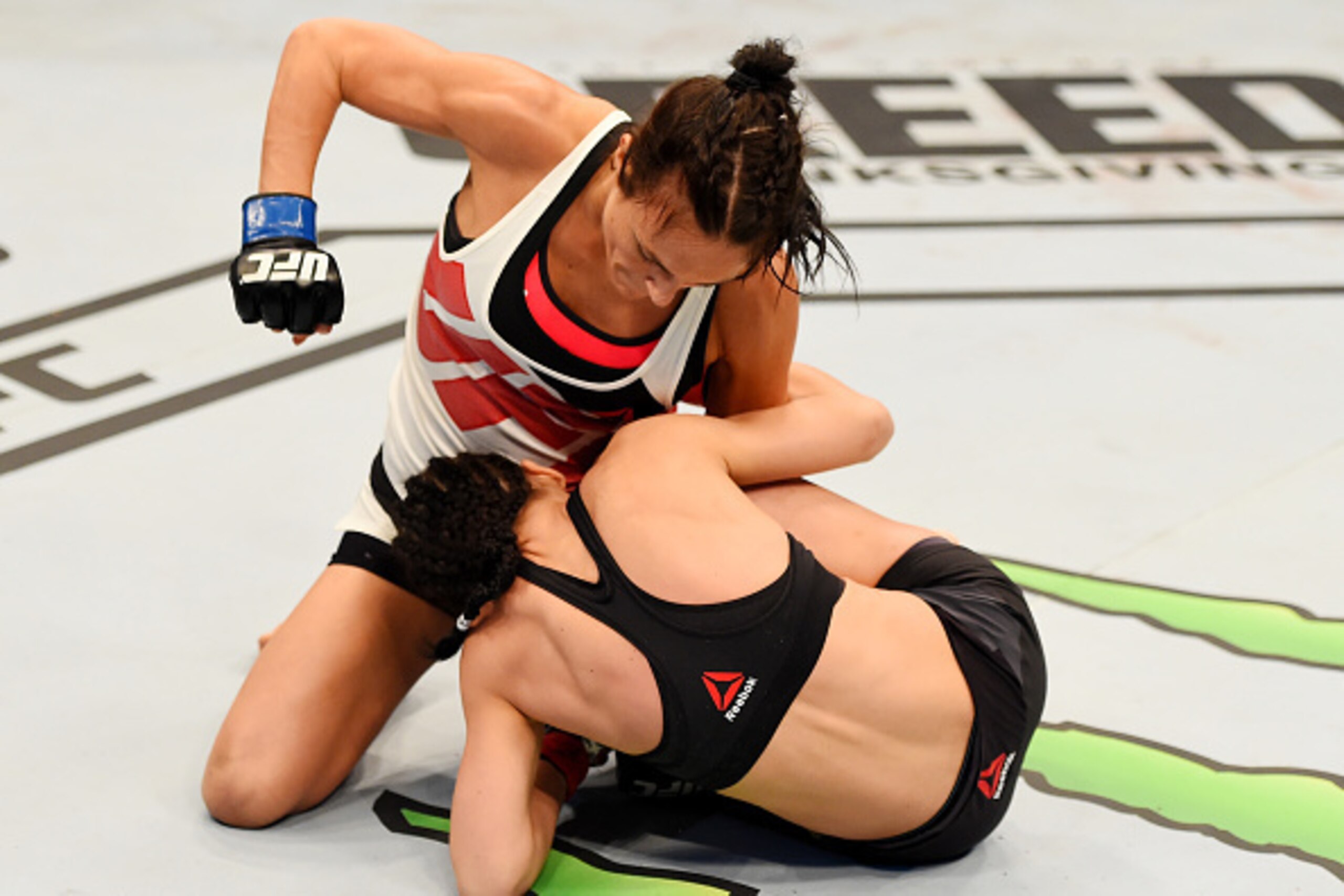 MELBOURNE, AUSTRALIA - NOVEMBER 15: Valerie Letourneau works from the top as she punches Joanna Jedrzejczyk (B) in their UFC women's strawweight championship bout during the UFC 193 event at Etihad Stadium on November 15, 2015 in Melbourne, Australia.  (P