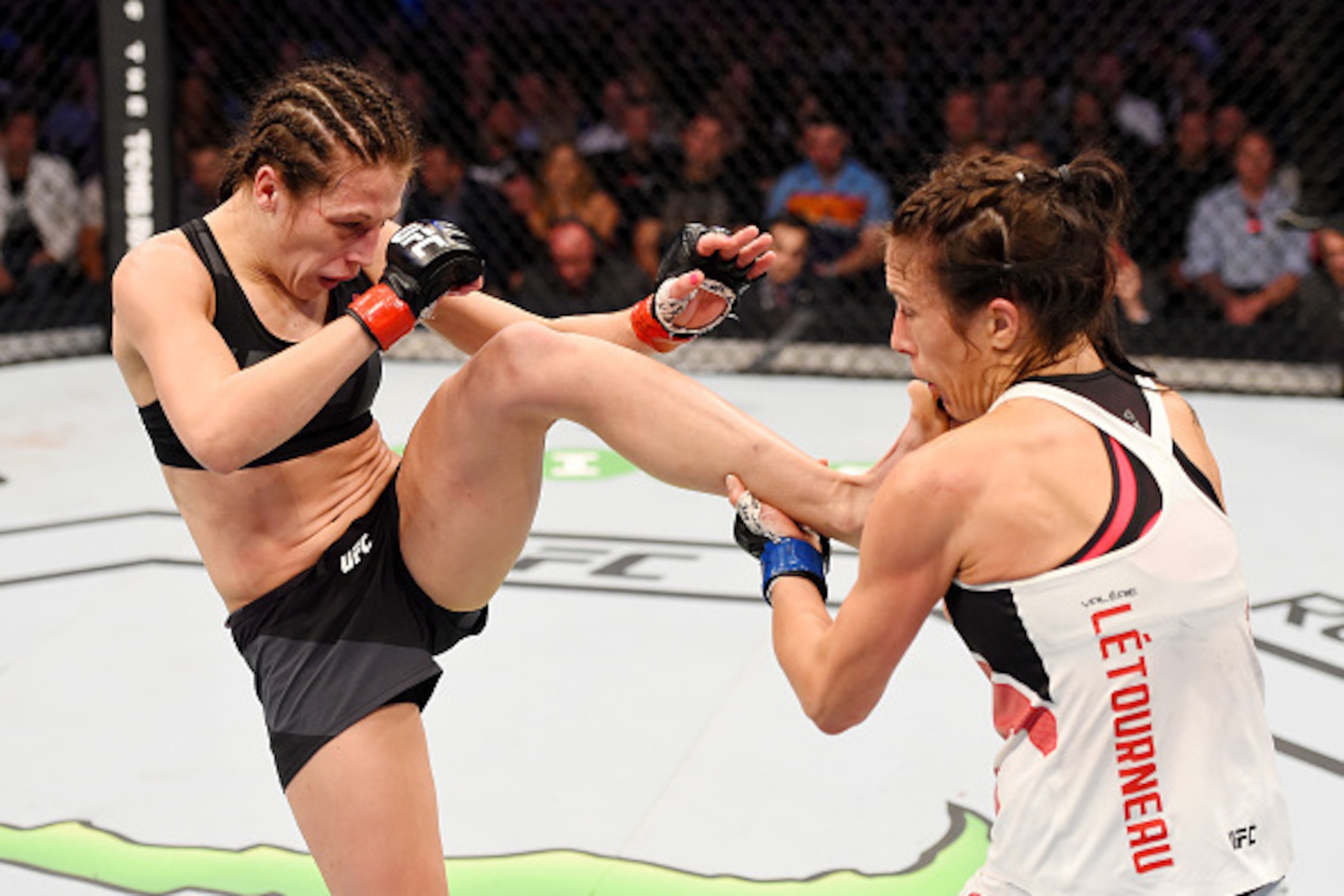 MELBOURNE, AUSTRALIA - NOVEMBER 15: (L-R) Joanna Jedrzejczyk kicks Valerie Letourneau in their UFC women's strawweight championship bout during the UFC 193 event at Etihad Stadium on November 15, 2015 in Melbourne, Australia.  (Photo by Josh Hedges/Zuffa 