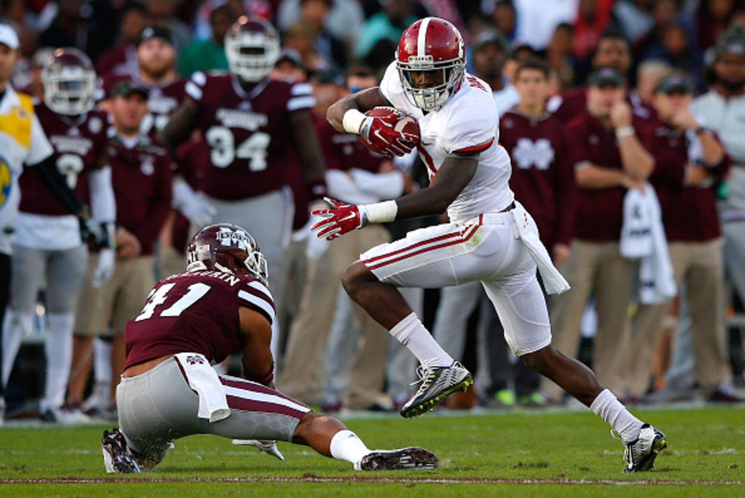 STARKVILLE, MS - NOVEMBER 14:  Calvin Ridley #3 of the Alabama Crimson Tide breaks a tackle attempt by Mark McLaurin #41 of the Mississippi State Bulldogs on the way to a touchdown at Davis Wade Stadium on November 14, 2015 in Starkville, Mississippi.  (P
