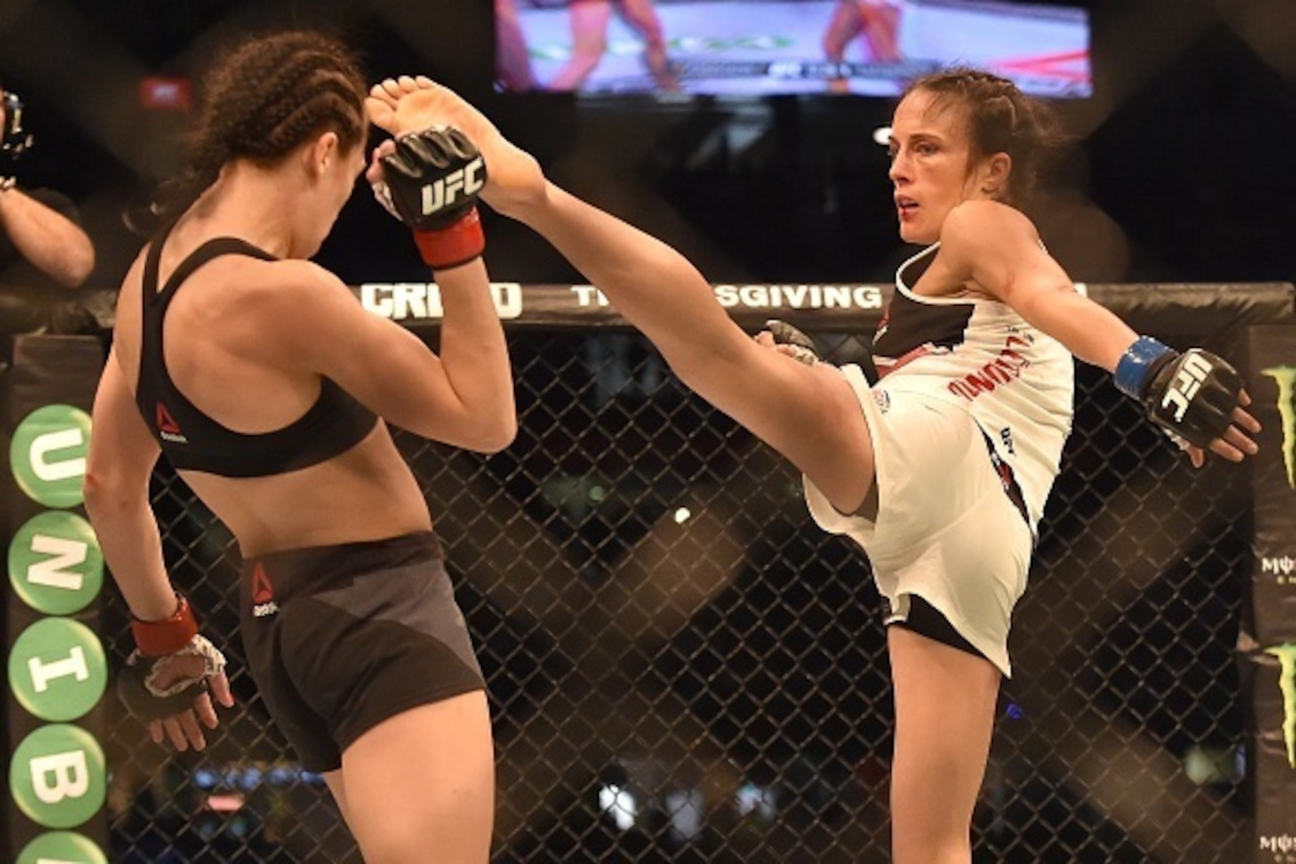 Joanna Jedrzejczyk of Poland dodges a kick from Valerie Letourneau of Canada (R) during the UFC Strawweight title fight in Melbourne on November 15, 2015.   RESTRICTED TO EDITORIAL USE NO ADVERTISING USE NO PROMOTIONAL USE NO MERCHANDISING USE.  AFP PHOTO