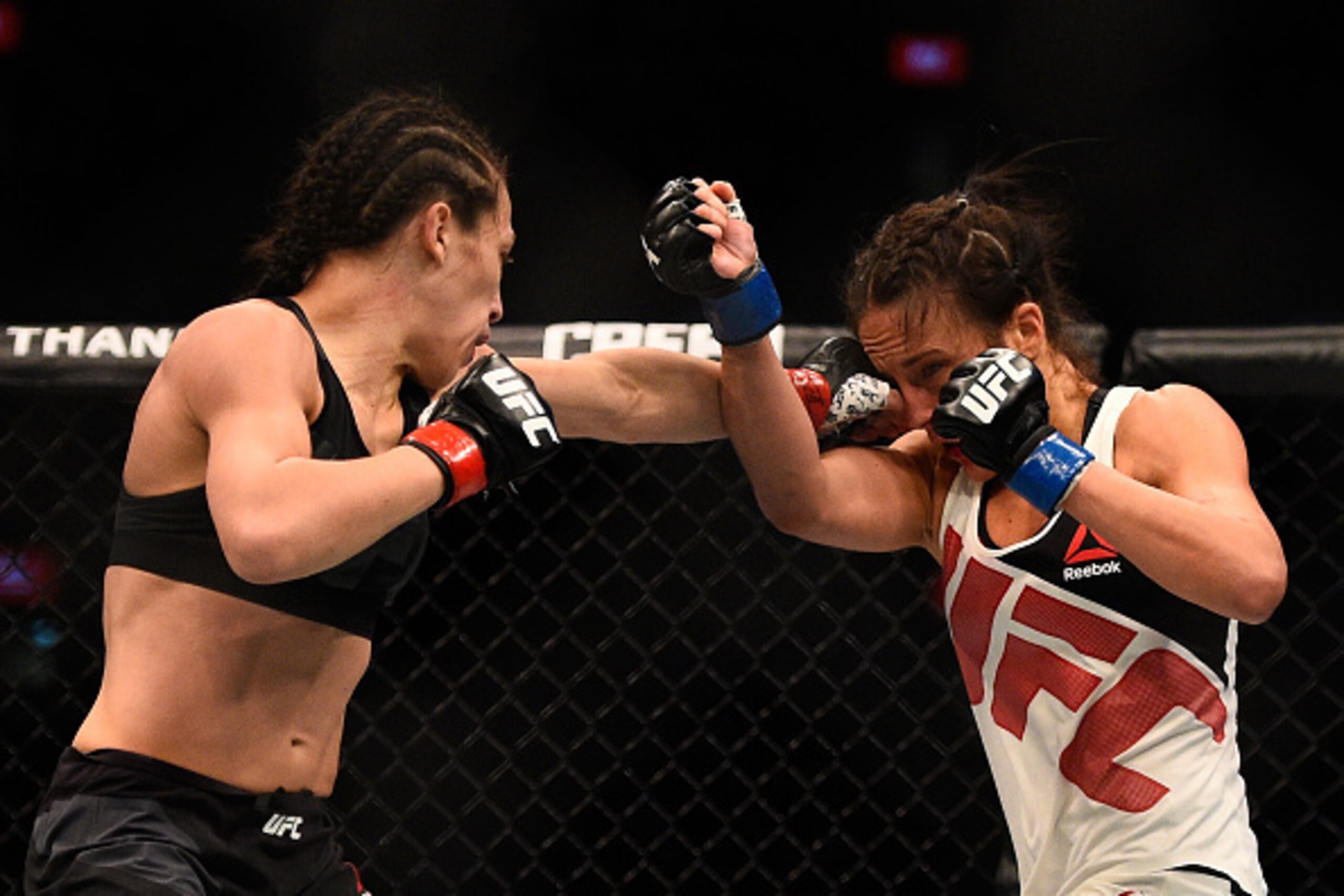 MELBOURNE, AUSTRALIA - NOVEMBER 15:  (L-R) Joanna Jedrzejczyk lands a left-handed punch against Valerie Letourneau in their UFC women's strawweight championship bout during the UFC 193 event at Etihad Stadium on November 15, 2015 in Melbourne, Australia. 
