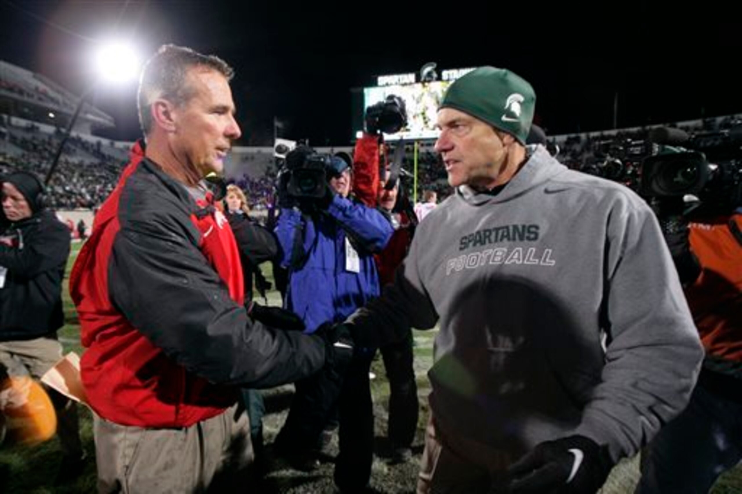 Ohio State HC Urban Meyer and Michigan State HC Mark Dantonio in 2014 Ohio State HC Urban Meyer and Michigan State HC Mark Dantonio in 2014
