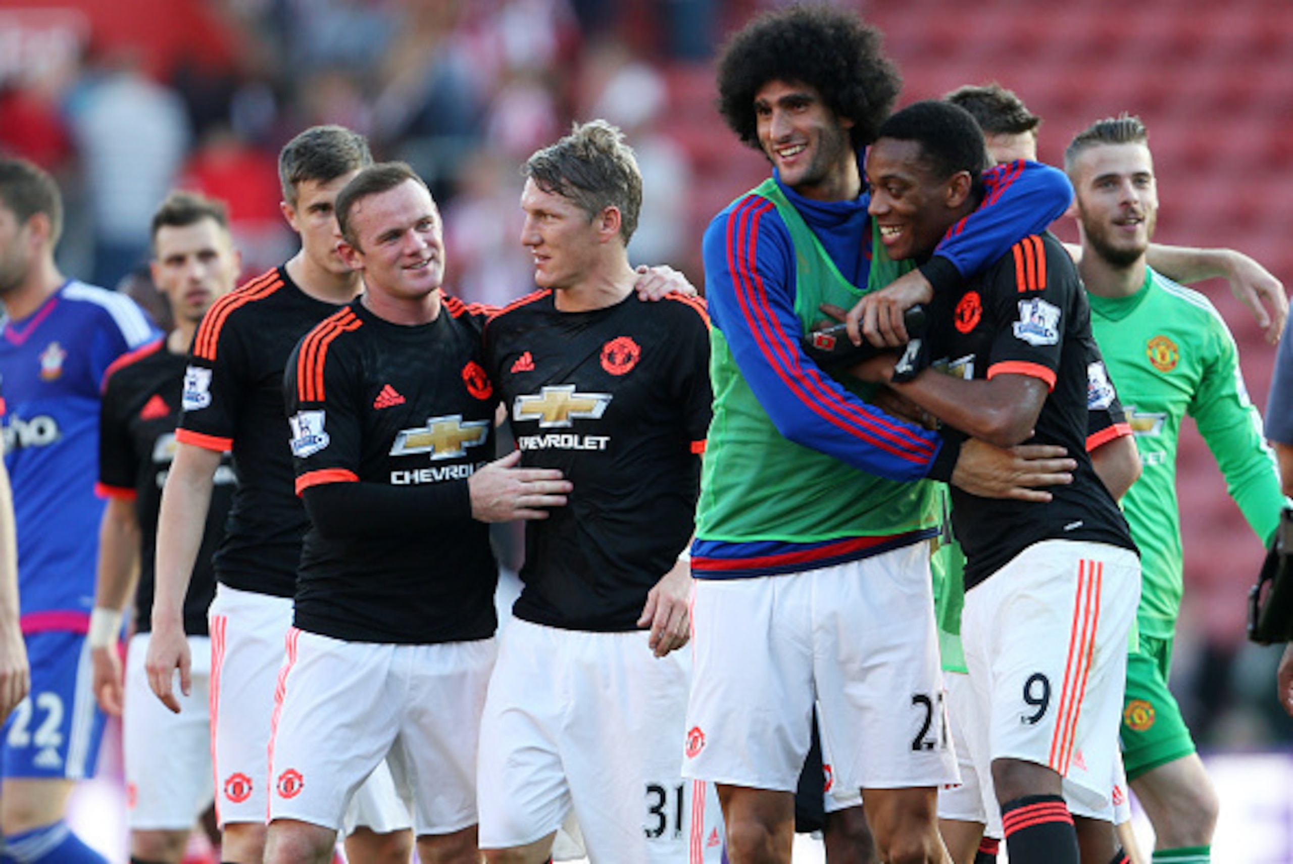 SOUTHAMPTON, ENGLAND - SEPTEMBER 20:  Marouane Fellaini of Manchester United hugs team mate Anthony Martial while Wayne Rooney hugs Bastian Schweinsteiger after the Barclays Premier League match at St Mary's stadium between Southampton and Manchester Unit