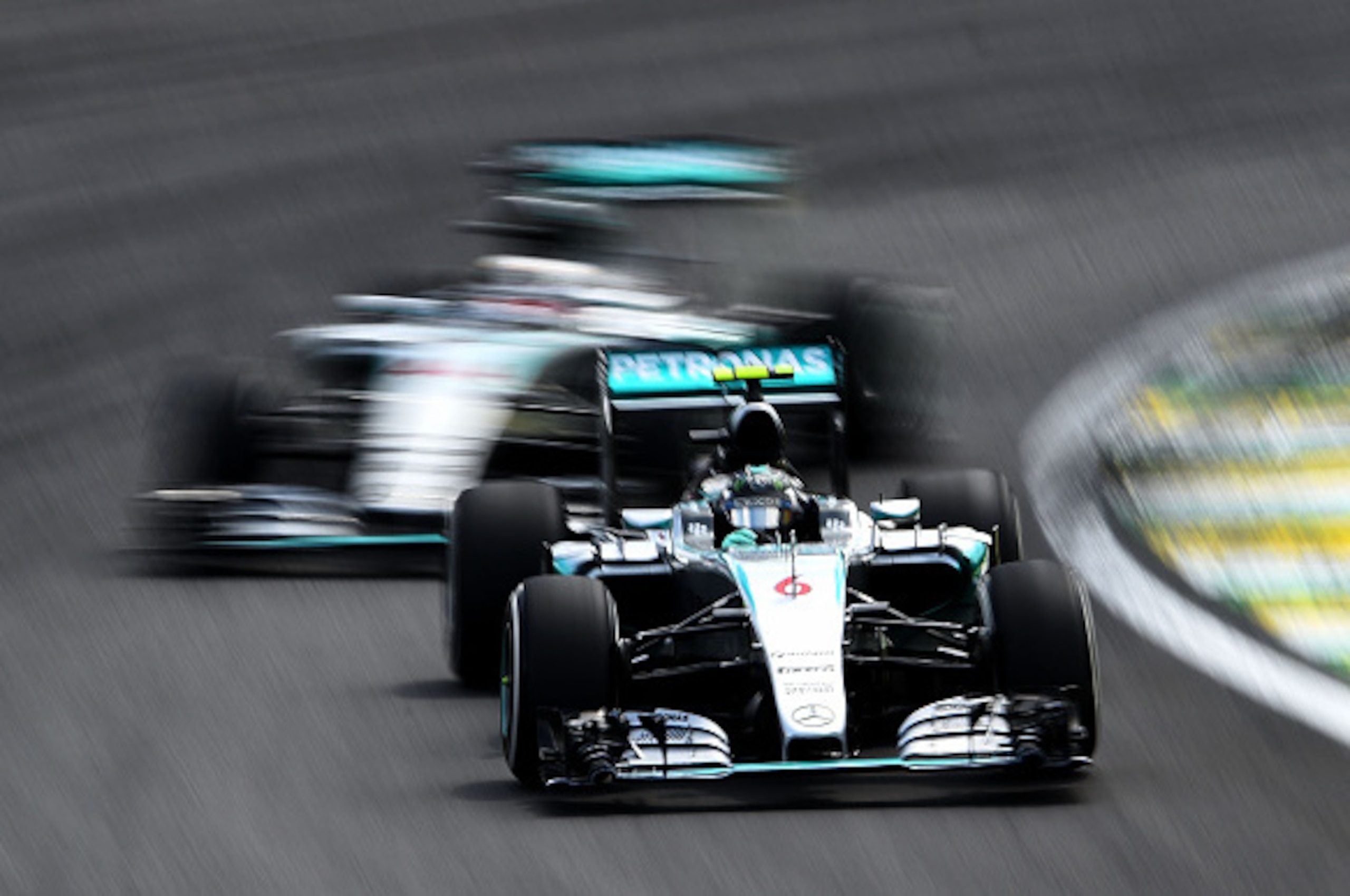 SAO PAULO, BRAZIL - NOVEMBER 15:  Nico Rosberg of Germany and Mercedes GP drives infront of Lewis Hamilton of Great Britain and Mercedes GP during the Formula One Grand Prix of Brazil at Autodromo Jose Carlos Pace on November 15, 2015 in Sao Paulo, Brazil