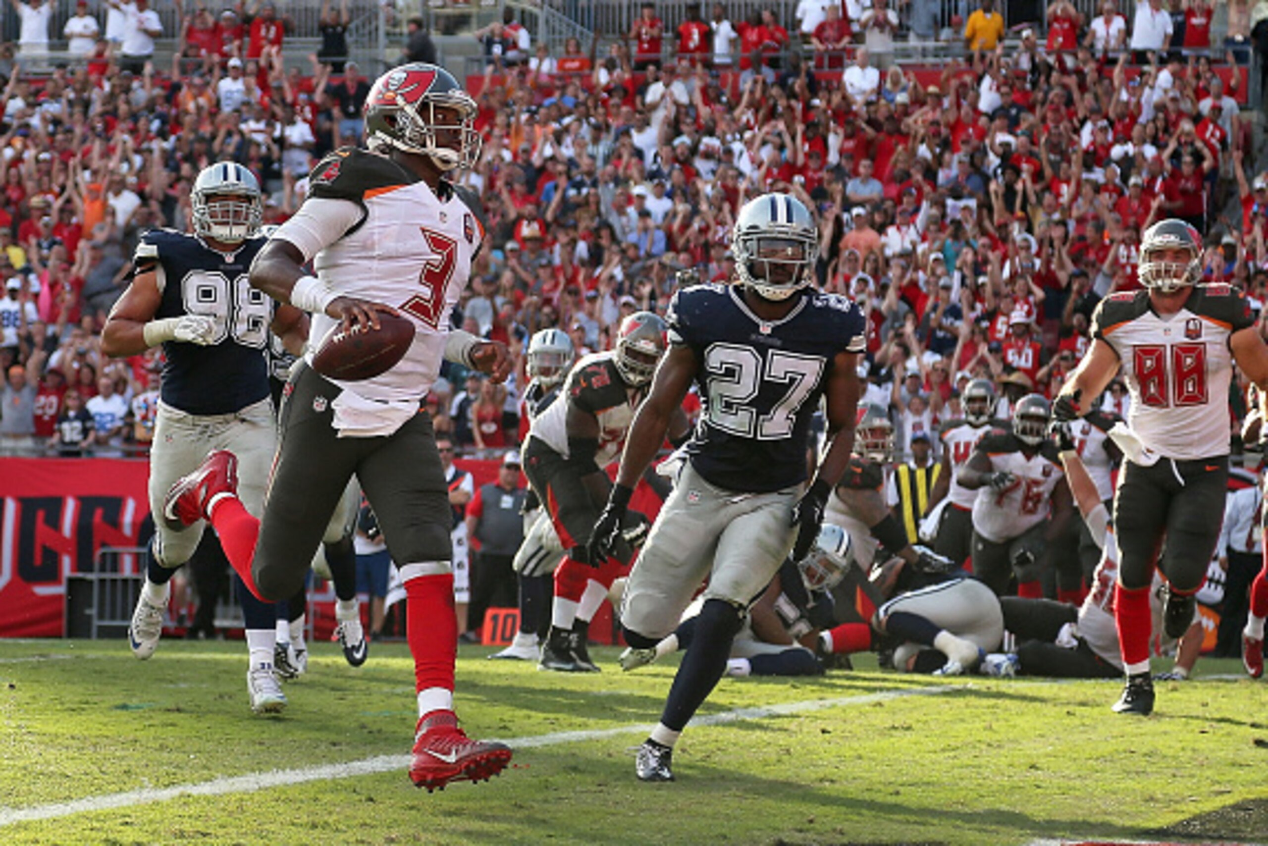 TAMPA, FL - NOVEMBER 15:  Jameis Winston #3 of the Tampa Bay Buccaneers scores a touchdown during a game against the Dallas Cowboys at Raymond James Stadium on November 15, 2015 in Tampa, Florida.  (Photo by Mike Ehrmann/Getty Images)