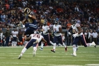 Nov 15, 2015; St. Louis, MO, USA; St. Louis Rams running back Todd Gurley (30) leaps over Chicago Bears strong safety Antrel Rolle (26) for a 31 yard gain during the first half at the Edward Jones Dome. Mandatory Credit: Jeff Curry-USA TODAY Sports