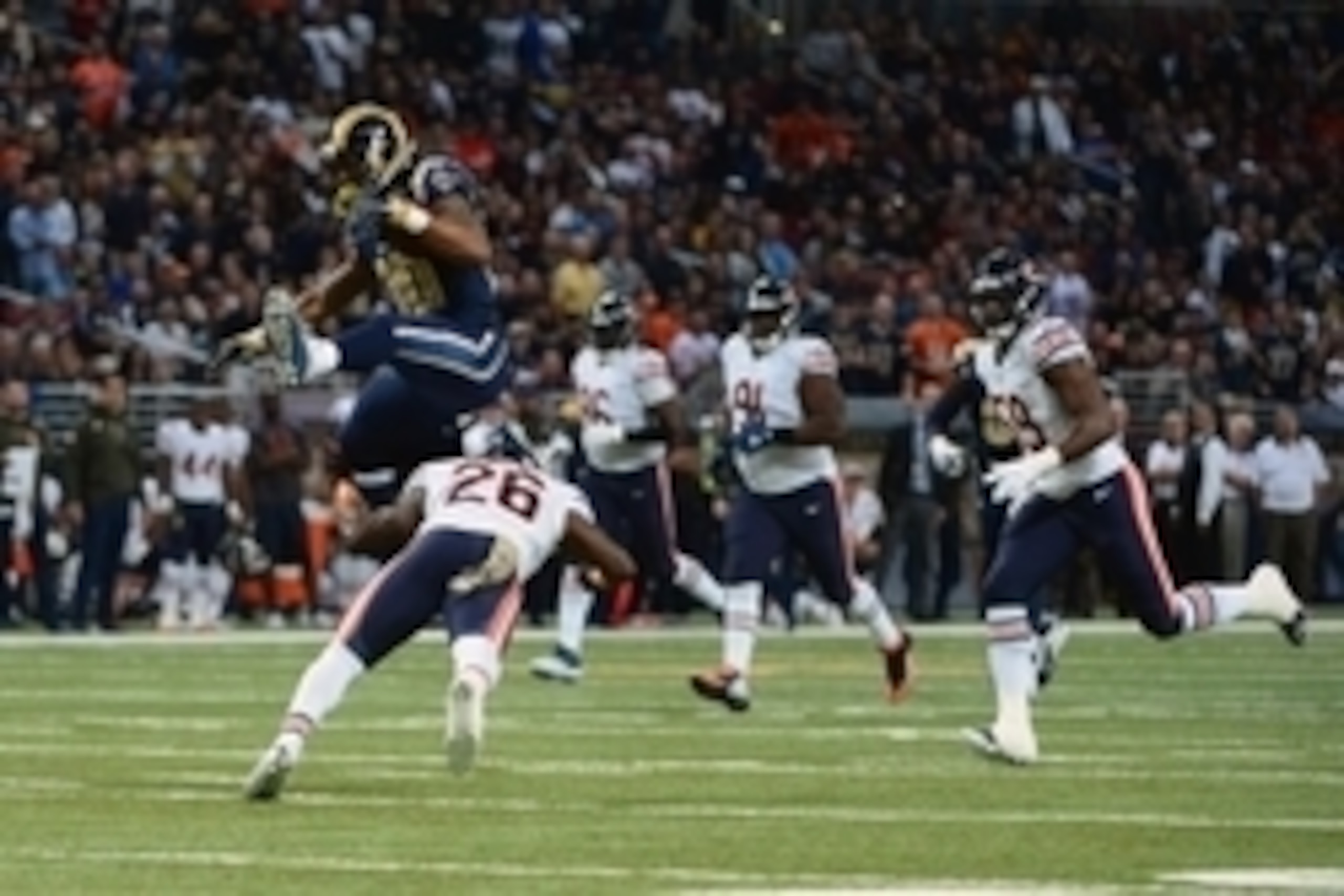 Nov 15, 2015; St. Louis, MO, USA; St. Louis Rams running back Todd Gurley (30) leaps over Chicago Bears strong safety Antrel Rolle (26) for a 31 yard gain during the first half at the Edward Jones Dome. Mandatory Credit: Jeff Curry-USA TODAY Sports