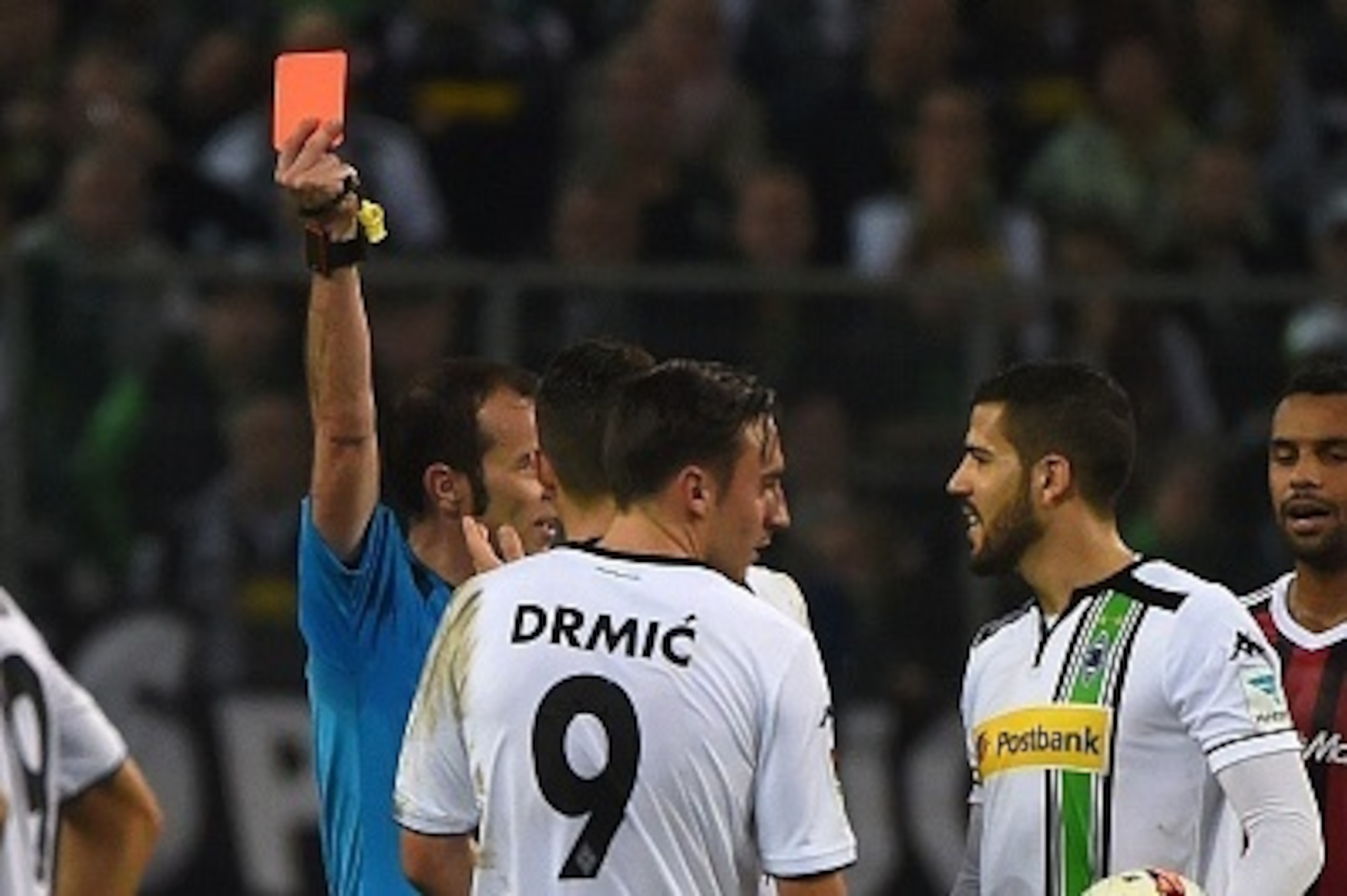 Referee Marco Fritz (2nd L) shows the red card to Moenchengladbach's Swiss midfielder Granit Xhaka (3rd L) next to Moenchengladbach's Spanish defender Alvaro Dominguez (2nd R) during the German first division football Bundesliga match Borussia Moenchengla