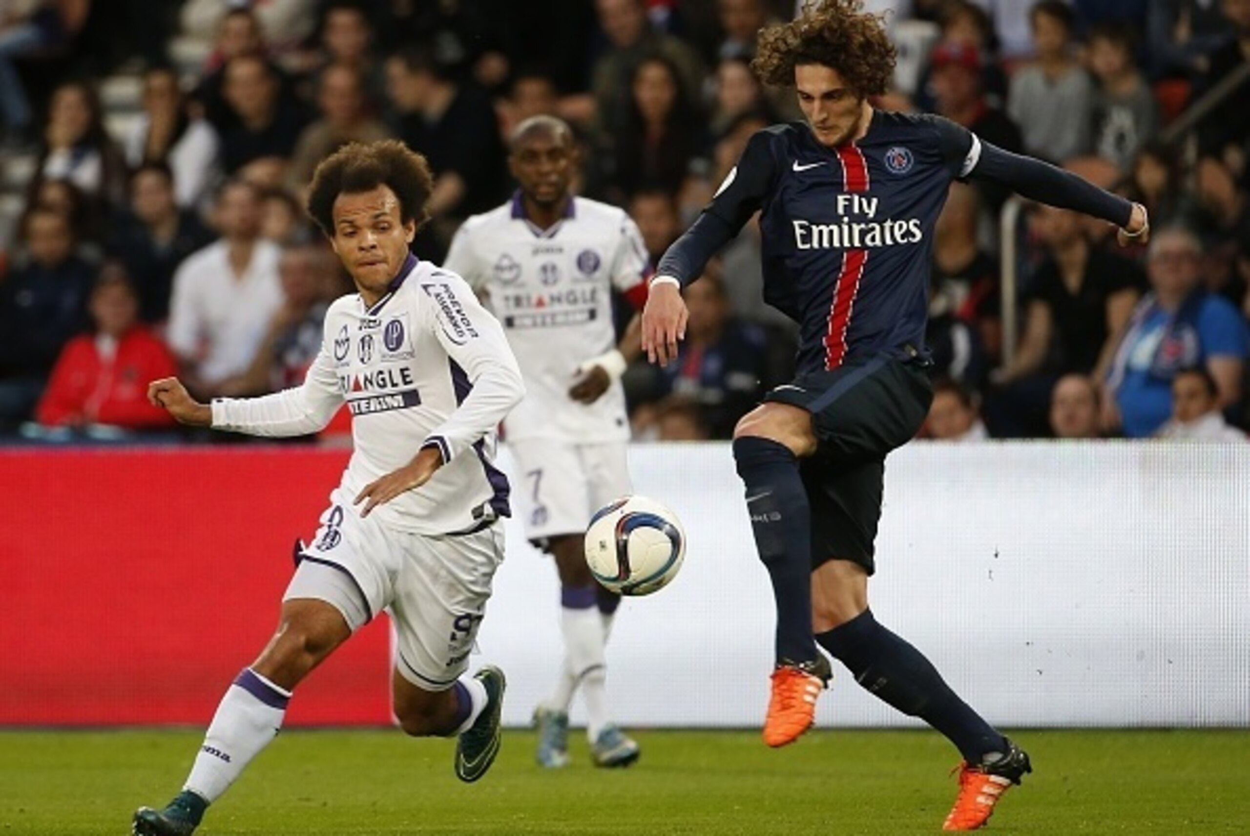 Toulouse's Danish forward Martin Braithwaite (L) vies with Paris Saint-Germain's French midfielder Adrien Rabiot during the French L1 football match between Paris Saint-Germain(PSG) and Toulouse (TFC) on November 7, 2015 at the Parc des Princes stadium, i