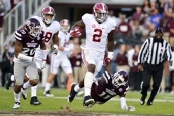 Nov 14, 2015; Starkville, MS, USA; Alabama Crimson Tide running back Derrick Henry (2) avoids a tackle by Mississippi State Bulldogs defensive back Kivon Coman (11) during a run that would result in a touchdown during the second quarter at Davis Wade Stad
