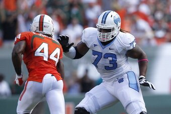 MIAMI GARDENS, FL - OCTOBER 13: Brennan Williams #73 of the North Carolina Tar Heels defends against Eddie Johnson #44 of the Miami Hurricanes on October 13, 2012 at Sun Life Stadium in Miami Gardens, Florida. The Tar Heels defeated the Hurricanes 18-14. 