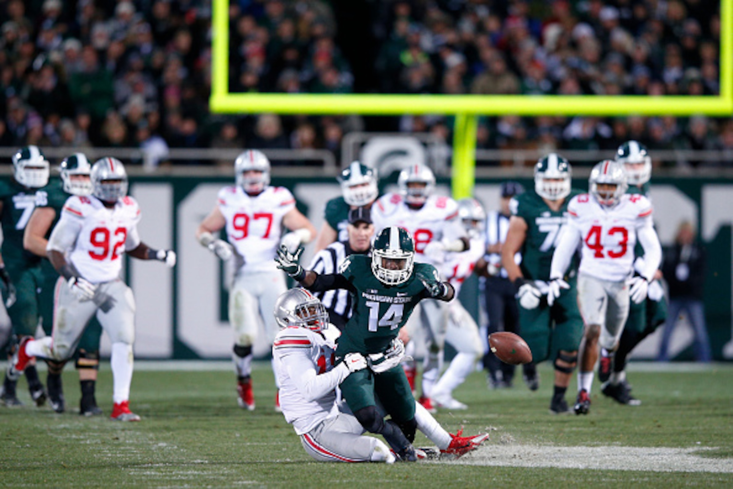 EAST LANSING, MI - NOVEMBER 8: Tony Lippett #14 of the Michigan State Spartans has a pass broken up by Doran Grant #12 of the Ohio State Buckeyes during the game at Spartan Stadium on November 8, 2014 in East Lansing, Michigan. Ohio State defeated Michiga