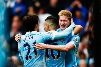 MANCHESTER, ENGLAND - OCTOBER 03:  Sergio Aguero (C) of Manchester City celebrates scoring his fourth and team's fifth goal with David Silva (L) and Kevin de Bruyne (R) during the Barclays Premier League match between Manchester City and Newcastle United 