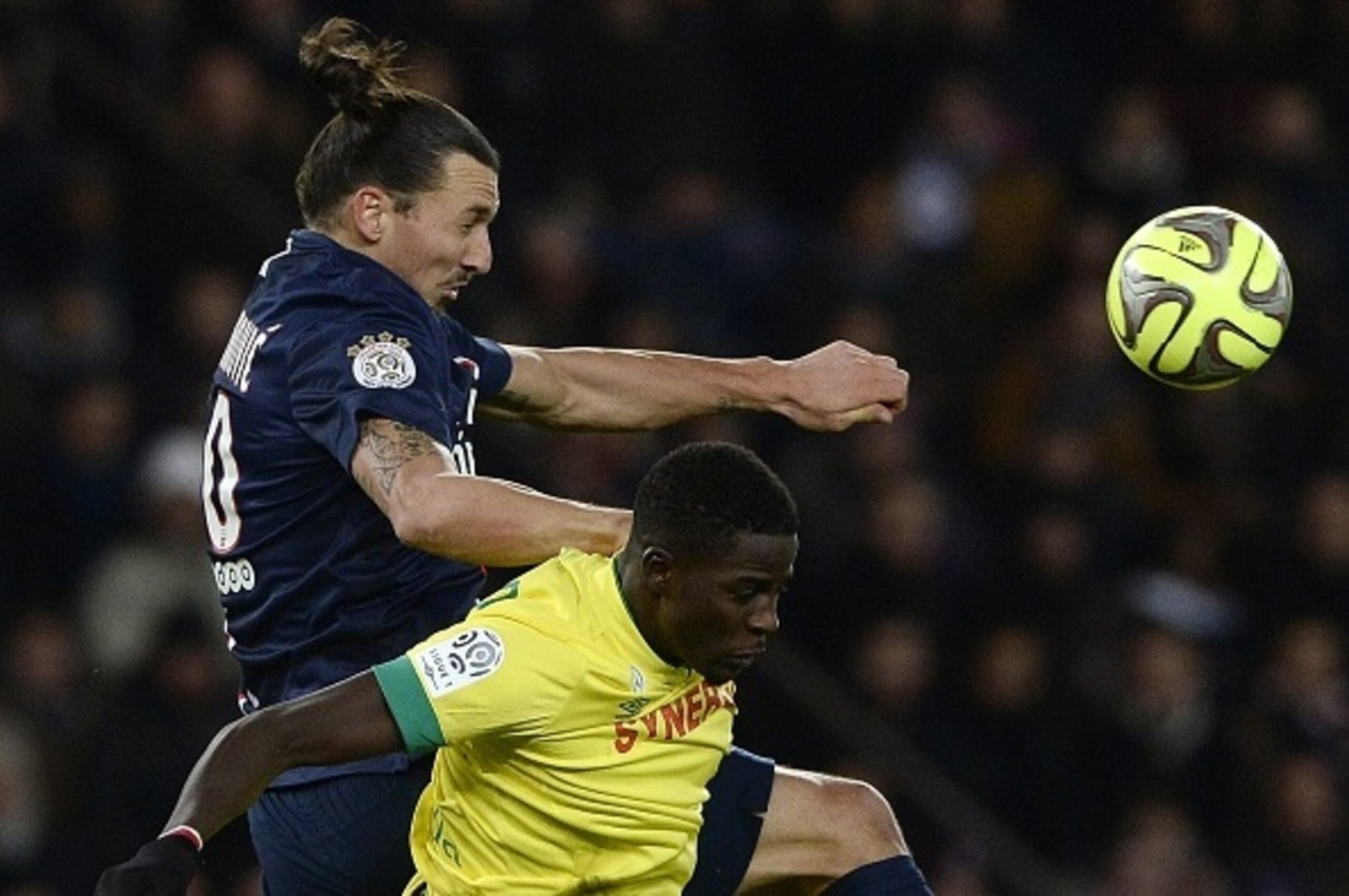 Nantes' Senegalese defender Papy Djilobodji heads the ball with Paris Saint-Germain's Swedish forward Zlatan Ibrahimovic (back) during the French L1 football match between Paris Saint-Germain (PSG) and Nantes at the Parc des Princes stadium in Paris on De