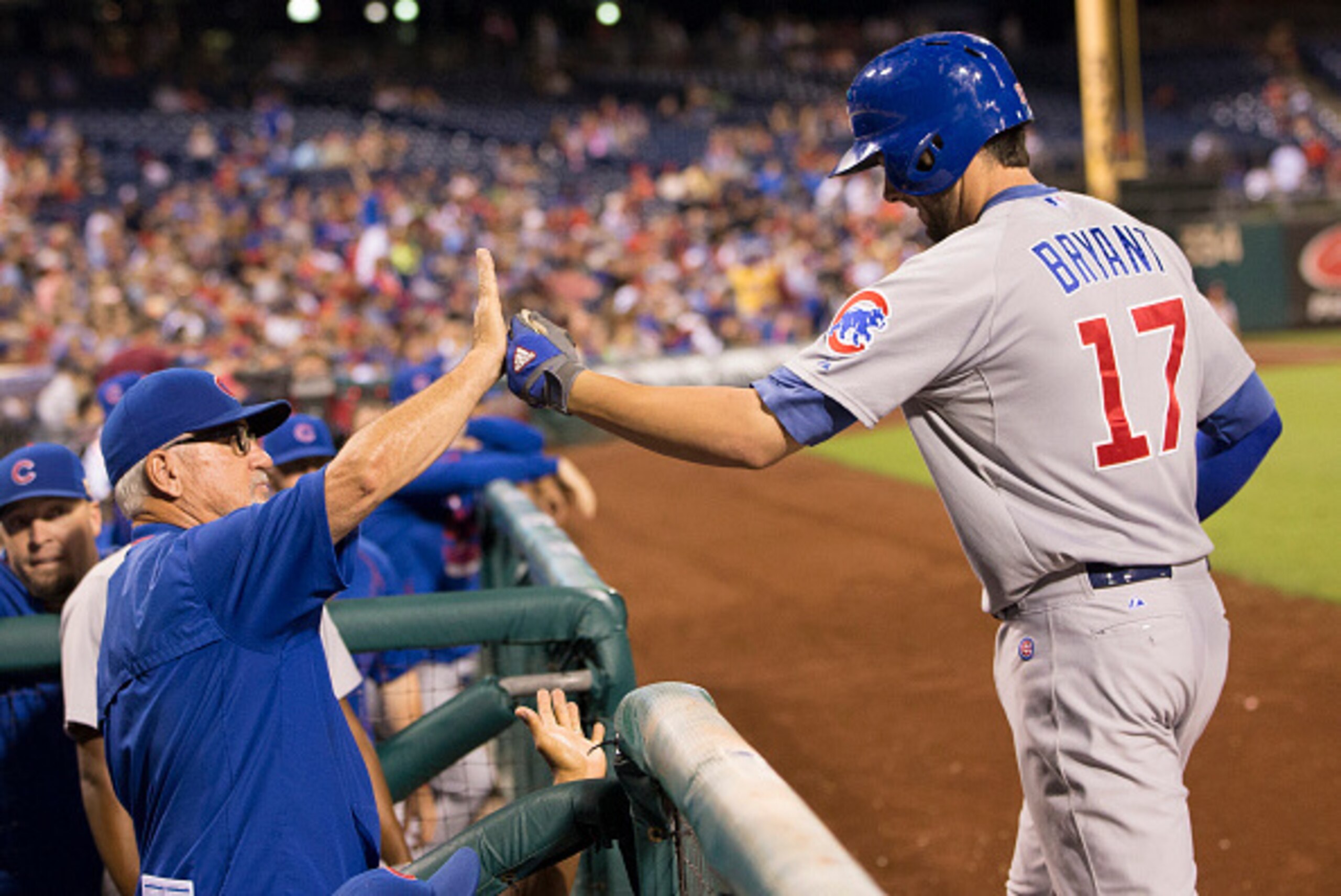 PHILADELPHIA, PA - SEPTEMBER 11: Manager Joe Maddon #70 of the Chicago Cubs high fives Kris Bryant #17 after a two-run homerun by Bryant in the top of the fifth inning against the Philadelphia Phillies on September 11, 2015 at Citizens Bank Park in Philad