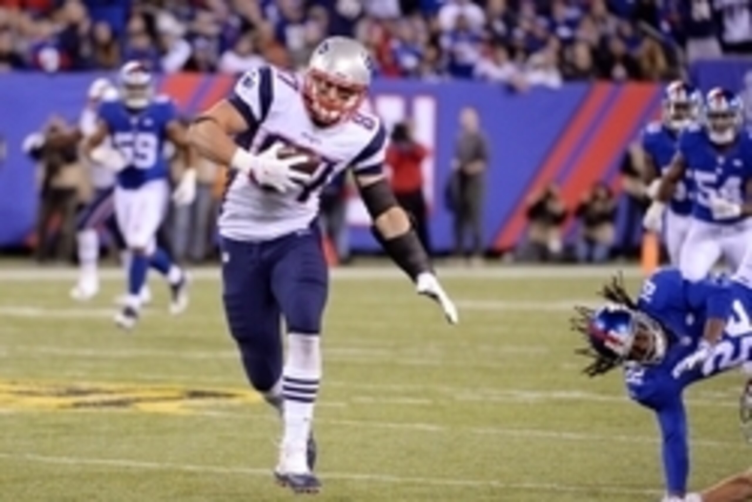 Nov 15, 2015; East Rutherford, NJ, USA; New England Patriots tight end Rob Gronkowski (87) breaks away from New York Giants strong safety Brandon Meriweather (22) to score a touchdown during the game at MetLife Stadium. Mandatory Credit: Robert Deutsch-US