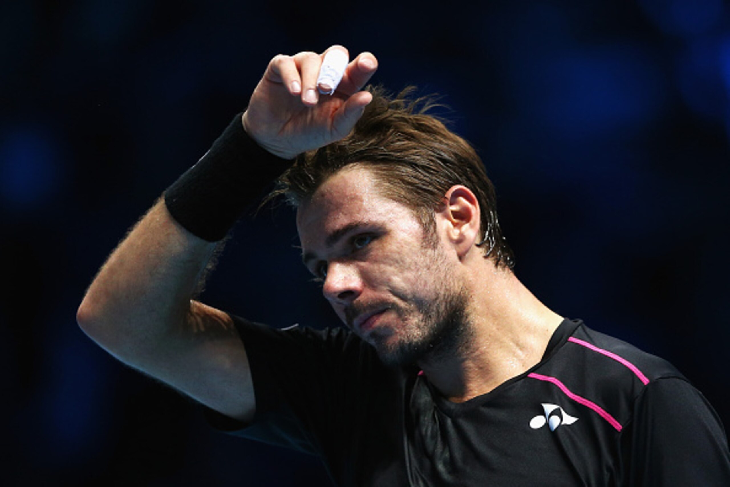 LONDON, ENGLAND - NOVEMBER 16:  Stanislas Wawrinka of Switzerland wipes his brow in his men's singles match against Rafael Nadal of Spain during day two of the Barclays ATP World Tour Finals at O2 Arena on November 16, 2015 in London, England.  (Photo by 