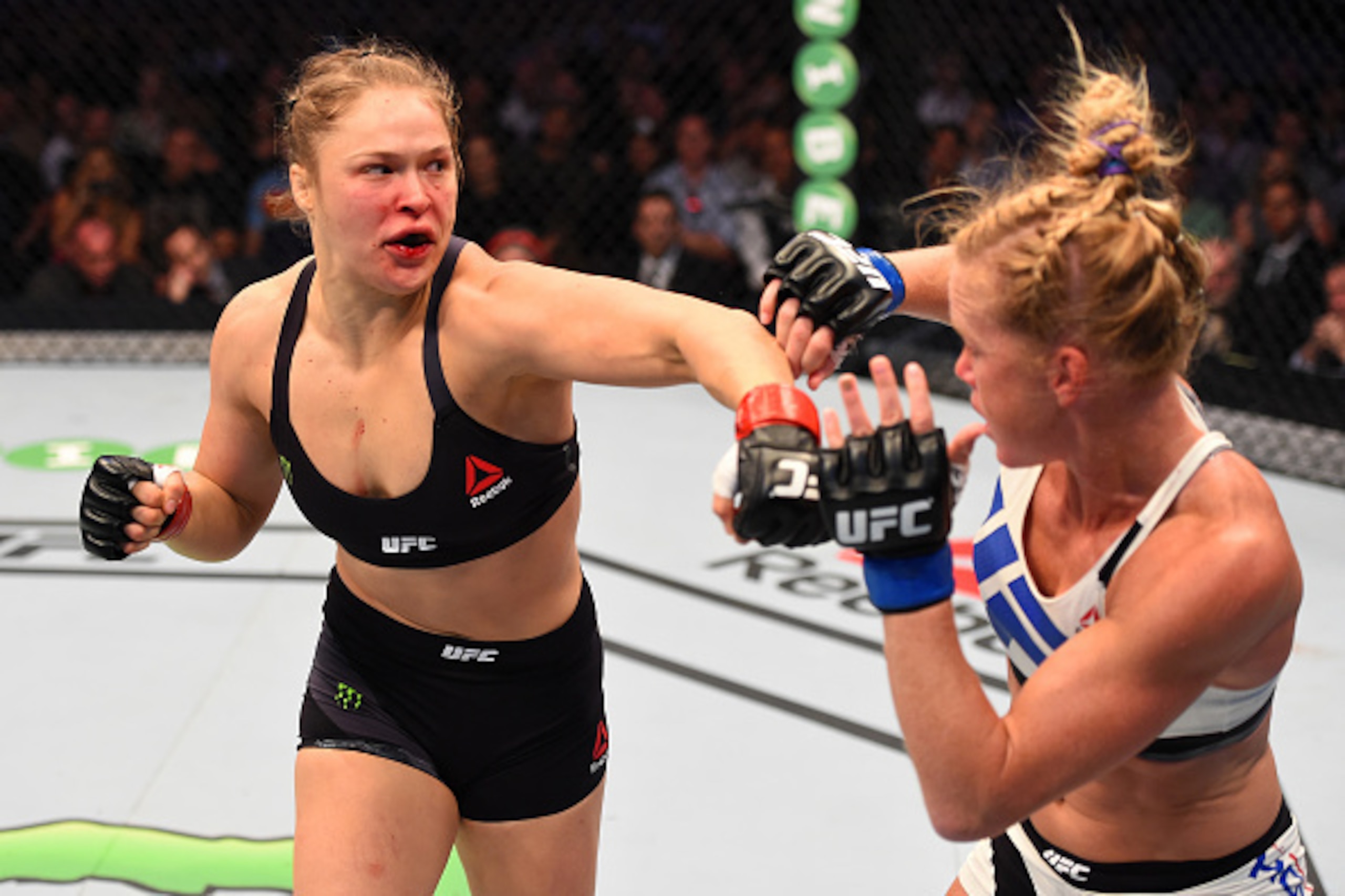 MELBOURNE, AUSTRALIA - NOVEMBER 15:  (L-R) Ronda Rousey of the United States punches Holly Holm of the United States in their UFC women's bantamweight championship bout during the UFC 193 event at Etihad Stadium on November 15, 2015 in Melbourne, Australi
