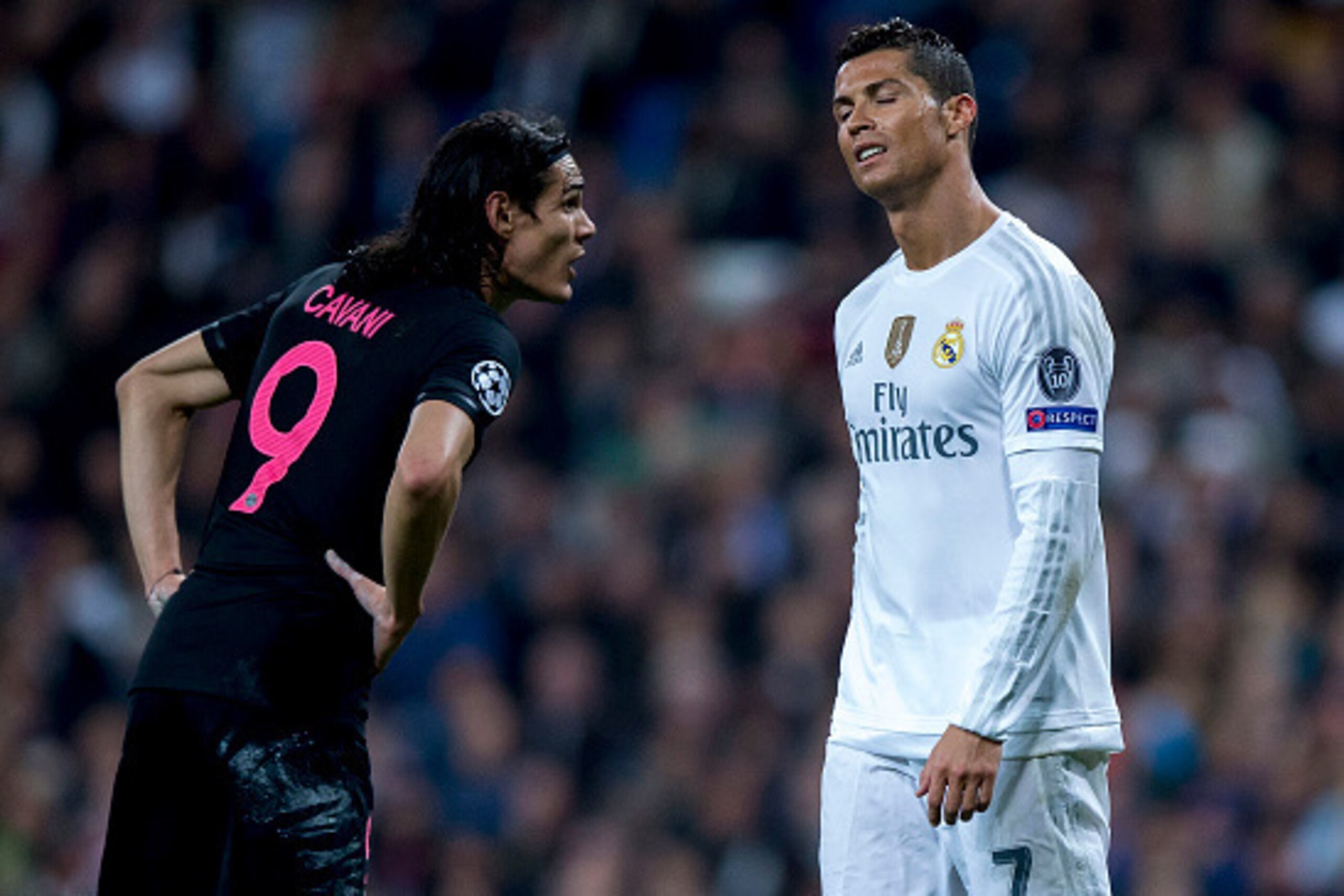 MADRID, SPAIN - NOVEMBER 03: Cristiano Ronaldo (R) of Real Madrid CF reacts as he fail to score as Edinson Cavani (L) of Paris Saint-Germain speaks to him during the UEFA Champions League Group A match between Real Madrid CF and Paris Saint-Germain at Est