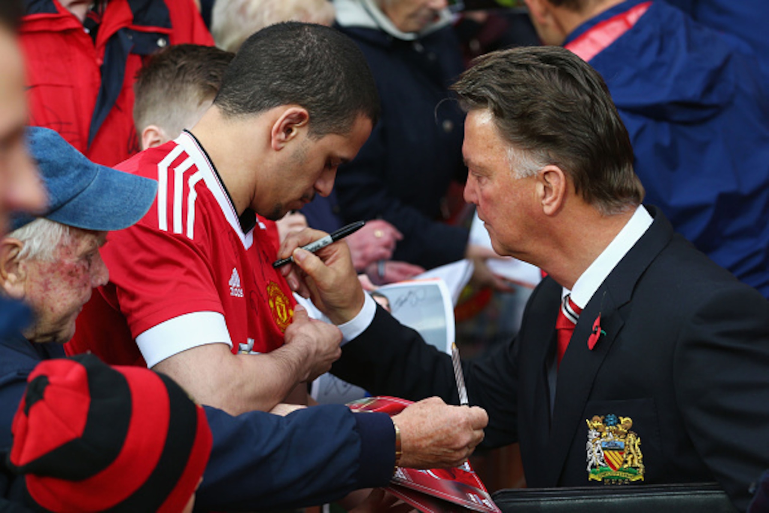 MANCHESTER, ENGLAND - NOVEMBER 07:  Louis van Gaal Manager of Manchester United signs autographs for fans prior to the Barclays Premier League match between Manchester United and West Bromwich Albion at Old Trafford on November 7, 2015 in Manchester, Engl
