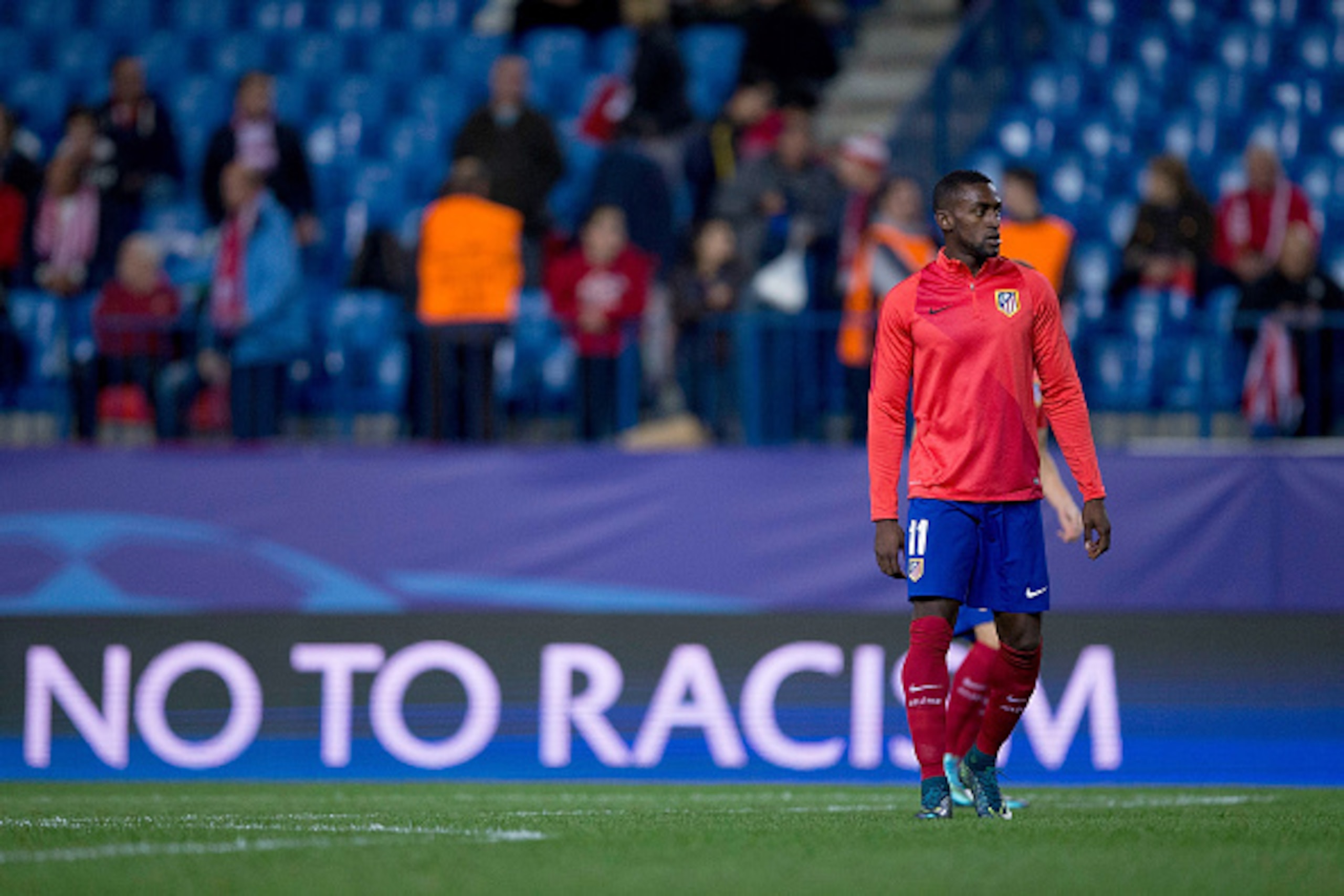 MADRID, SPAIN - OCTOBER 21:  Jackson Arley Martinez  of Atletico de Madrid leaves the picth ahead the Uefa No to Racism logo displayed on a screen after his warming up before the UEFA Champions League Group C match between Club Atletico de Madrid and FC A